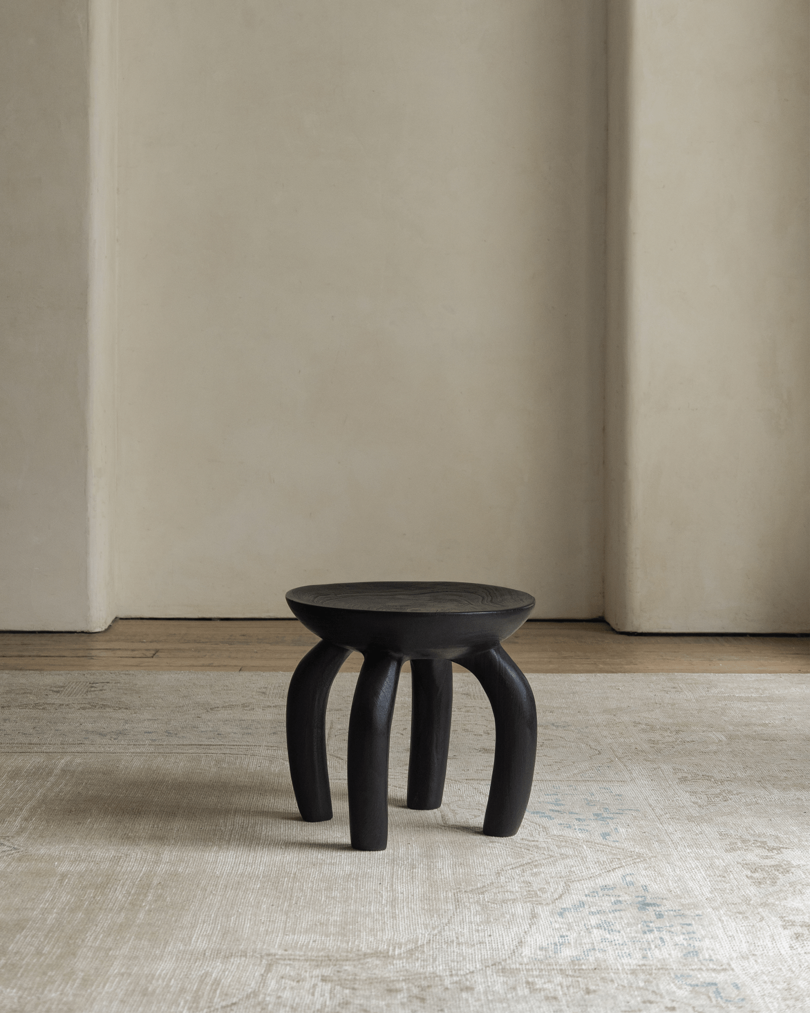 Handcrafted solid wood Jelly Stool, elegant black finish, unique design, sustainable living room furniture