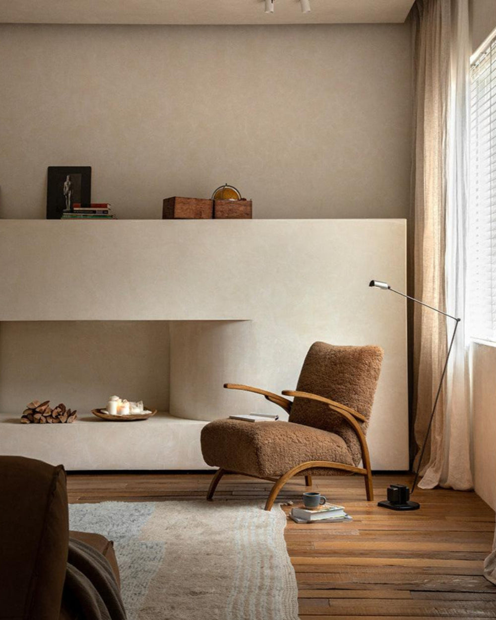 Nebula Lounge Chair in shearling upholstery and red oak frame, displayed in a cozy living room setting.