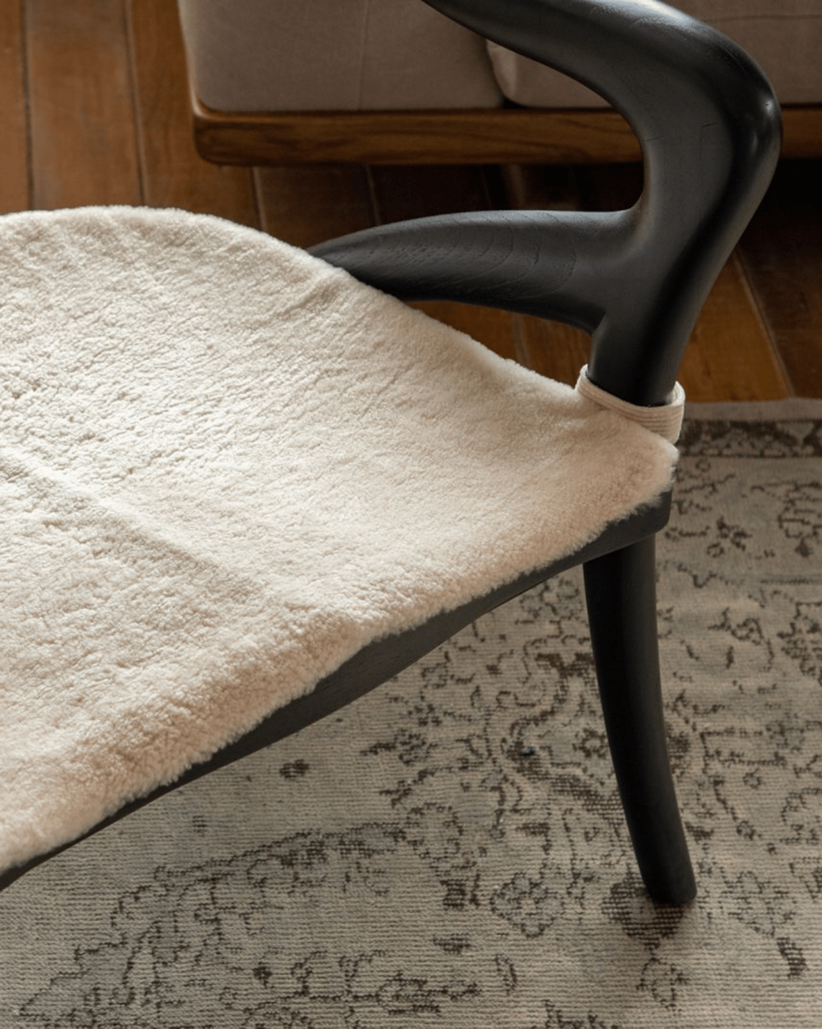 Olivia Chair detail: Cream fabric seat on black teak wood frame, modern design