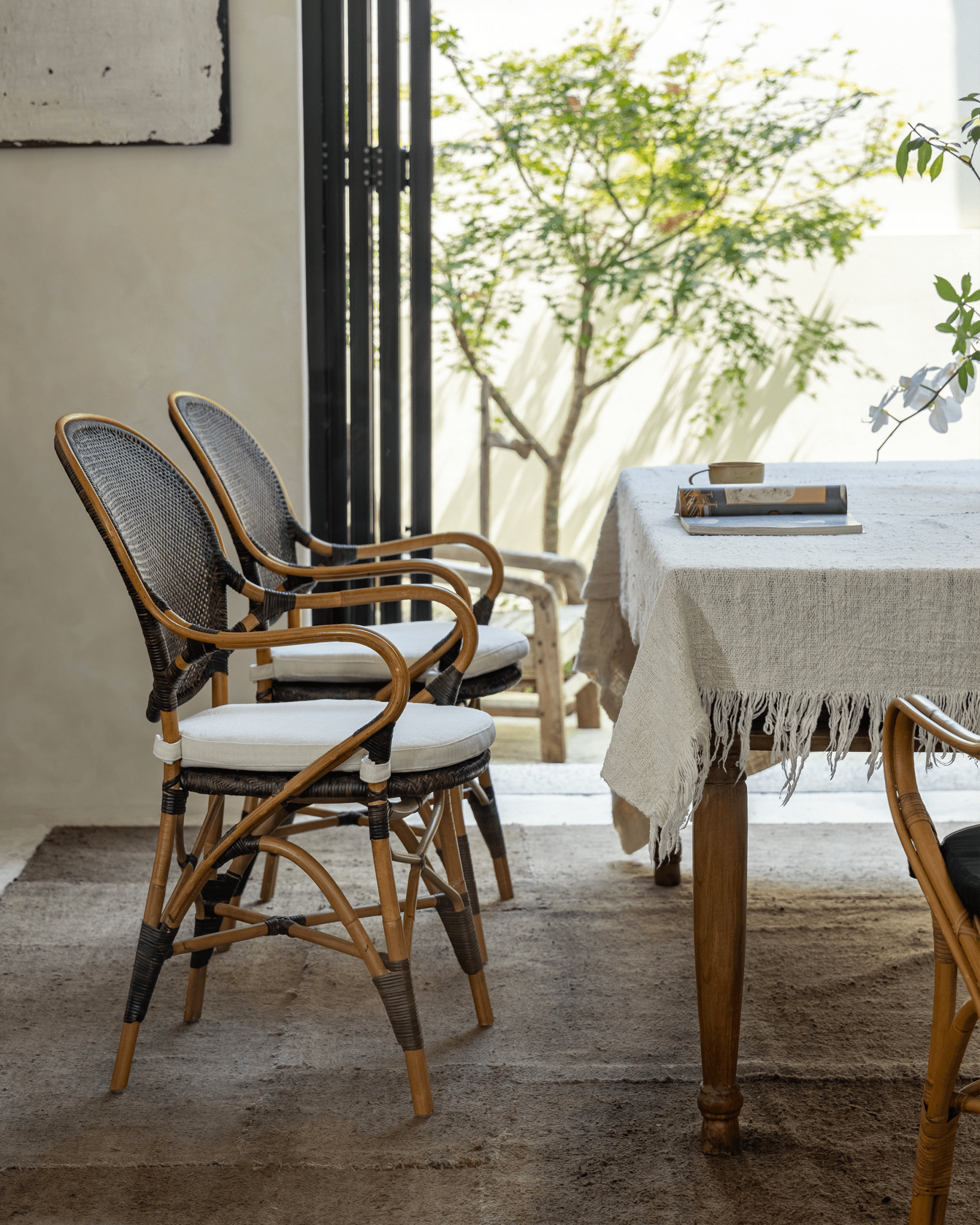 Areca Rattan Chairs: handwoven backrest, white cushions, and natural design. Natural comfort.