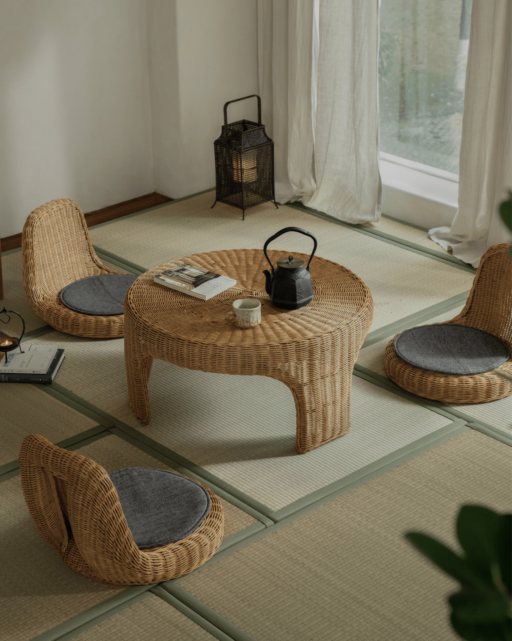 Lotus Tatami Set: Rattan tea table and chairs with gray cushions, creating a zen tea room ambiance