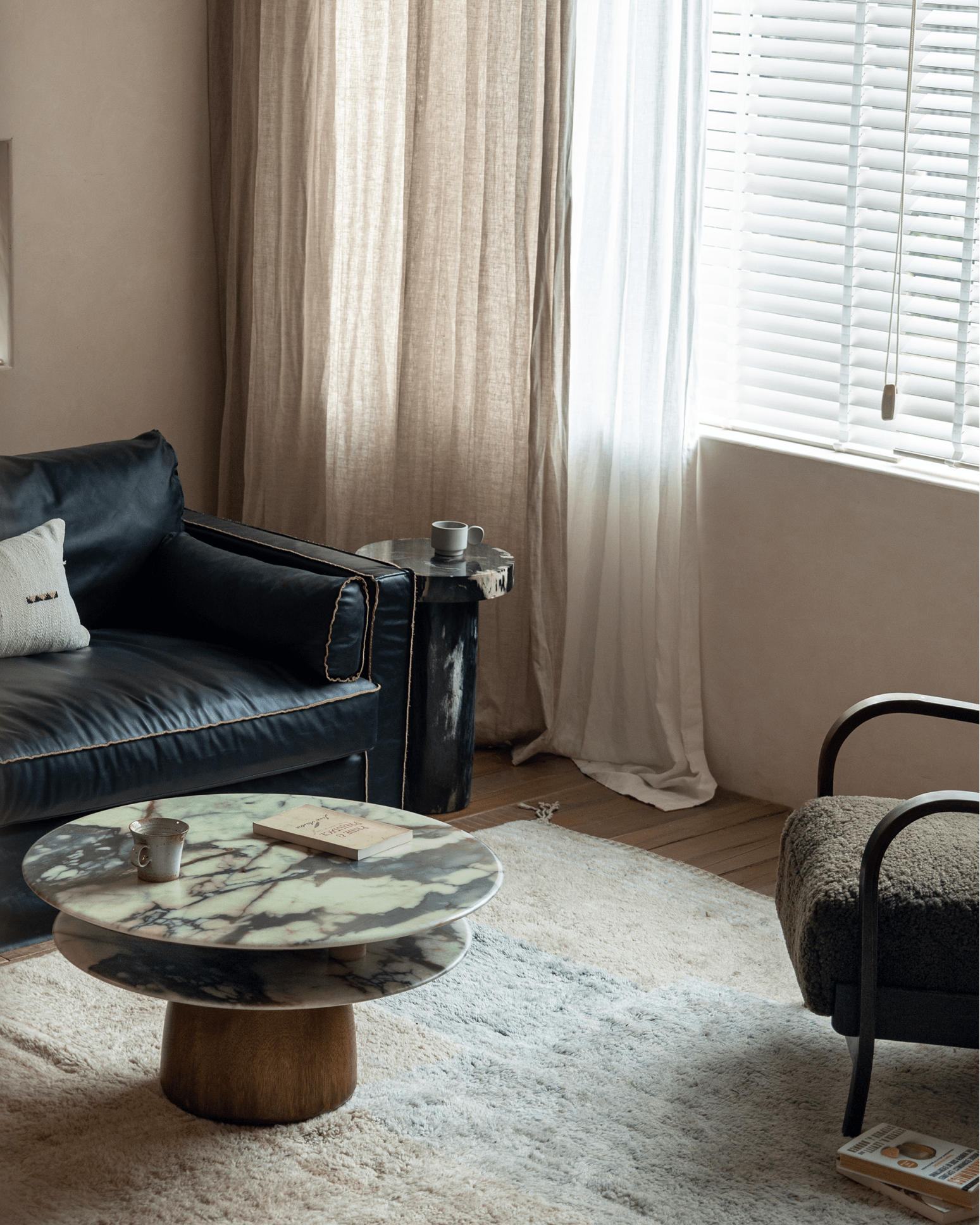 Dorothy Side Table in a living room setting with crystal stone top and rain wood base. Elegant decor.