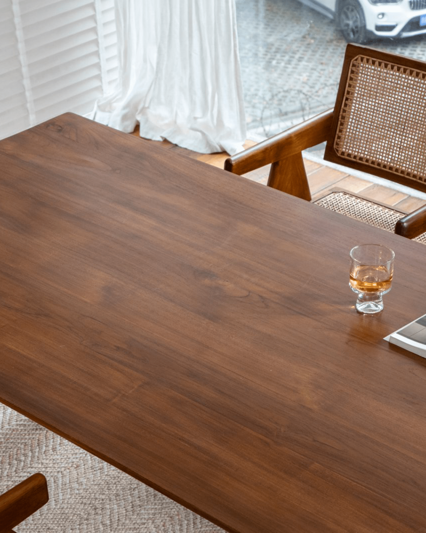Easy Dining Table, showcasing African teak surface with drink and chair, perfect for dining or work in a minimalist setting