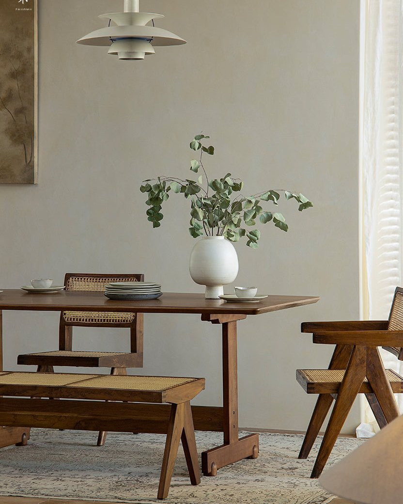 Hoof Dining Table in a cozy dining setting with I-shaped base, solid wood table, ZHUOMU brand, woven chairs and bench.