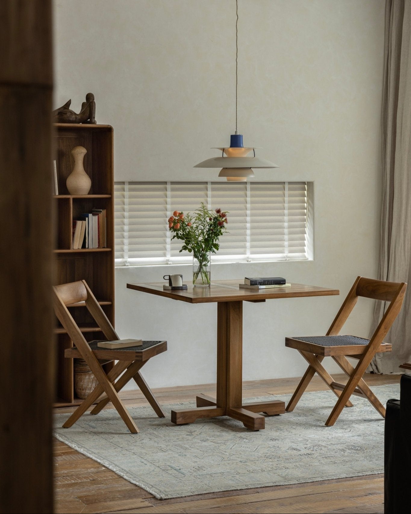 Felix Square Teak Table with chairs in a dining room setting, showcasing Indonesian teak wood design