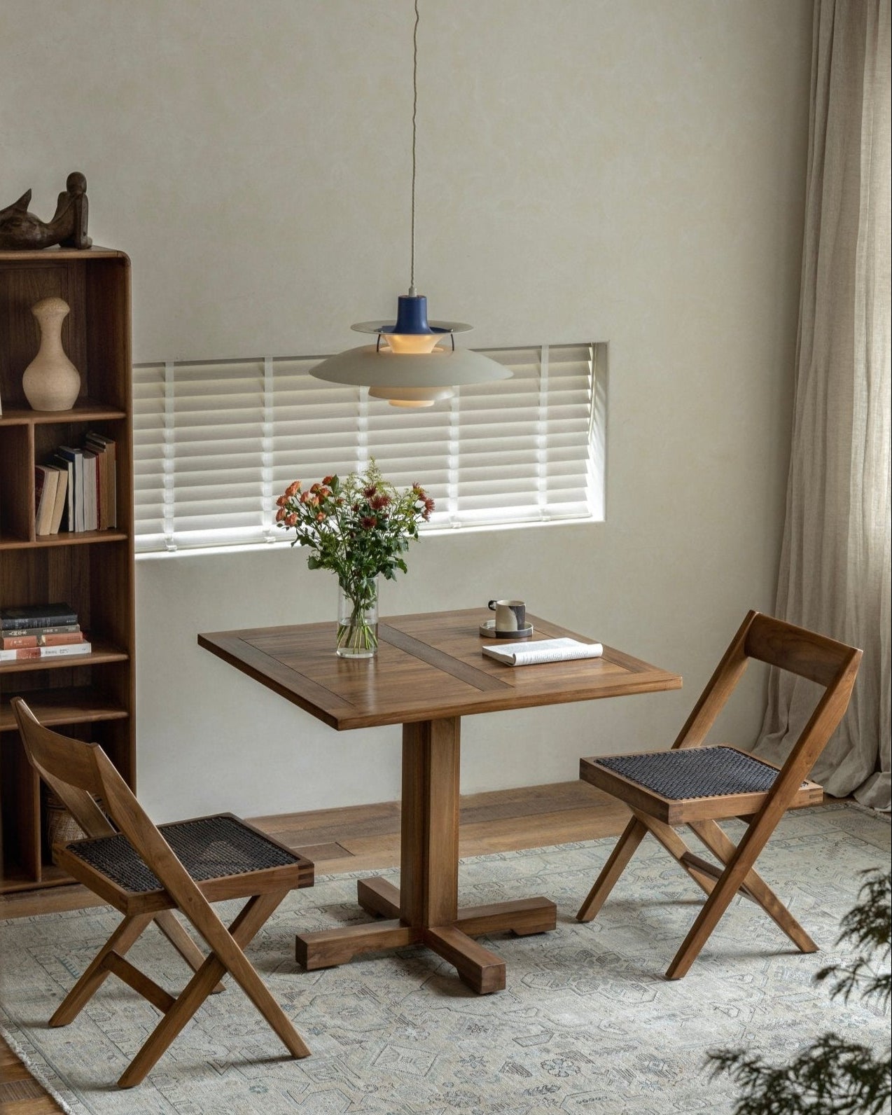 Felix Square Teak Table in dining room setting with wooden chairs, perfect for dining