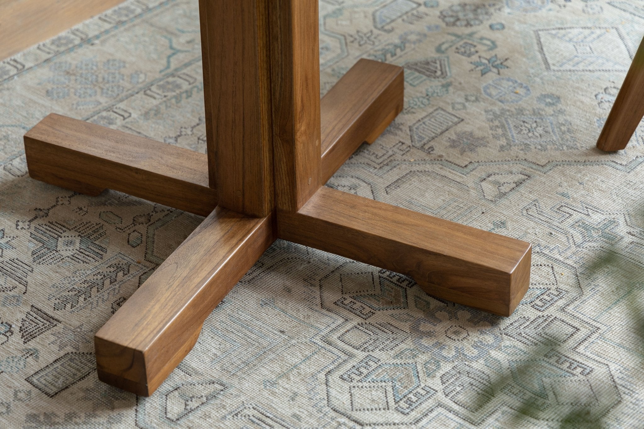 Ruby Teak Round Table base detail: solid wood legs and cross base design