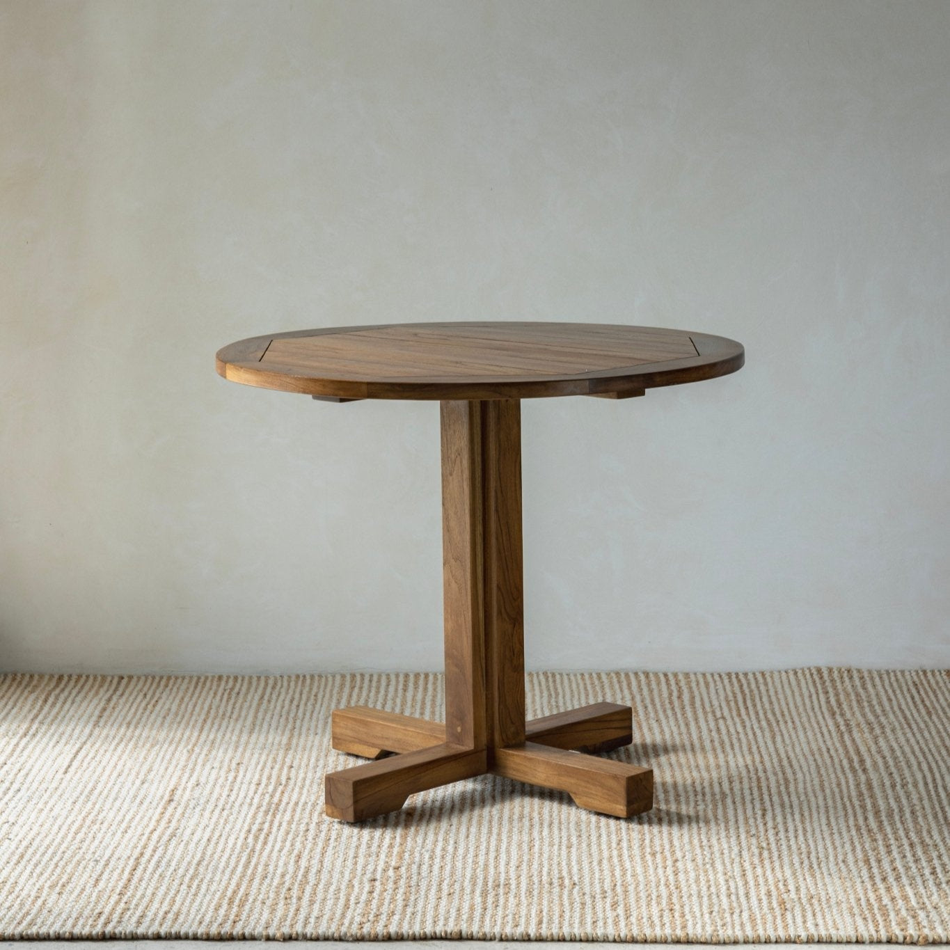Ruby Teak Round Table - Solid wood round table with a reinforced desktop and sturdy column legs