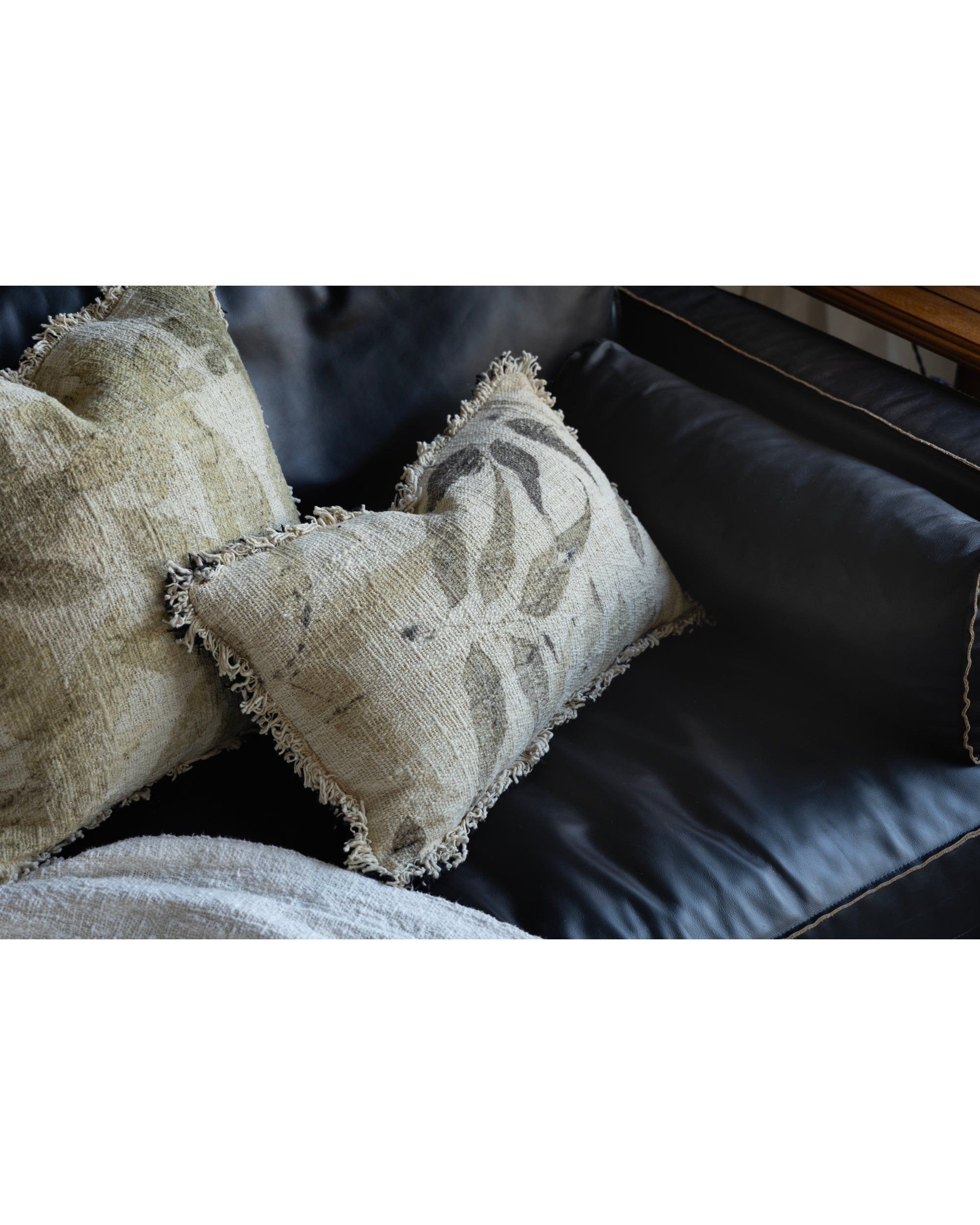 Textured Verda Pillow: cotton, hand-crocheted, plant-print motifs & frayed edge.