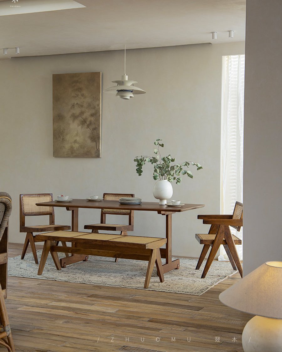 Hoof Dining Table in a cozy dining room setting, solid wood with I-shaped base, rattan chairs and bench, ZHUOMU brand