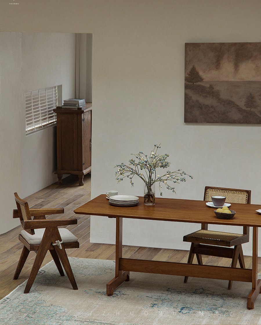Hoof Dining Table in a dining setting, solid wood I-shaped base, ZHUOMU brand, warm brown finish, wooden chairs, and a rug.