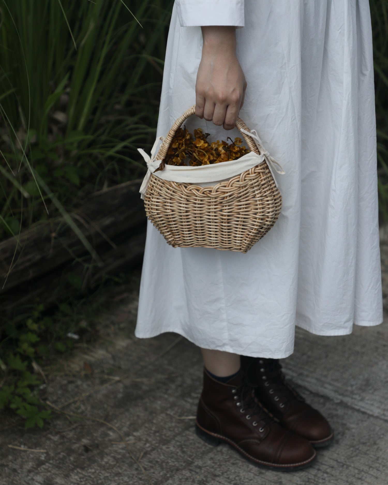 Nora Clutch: Handwoven rattan clutch basket with cotton lining and dried flowers.