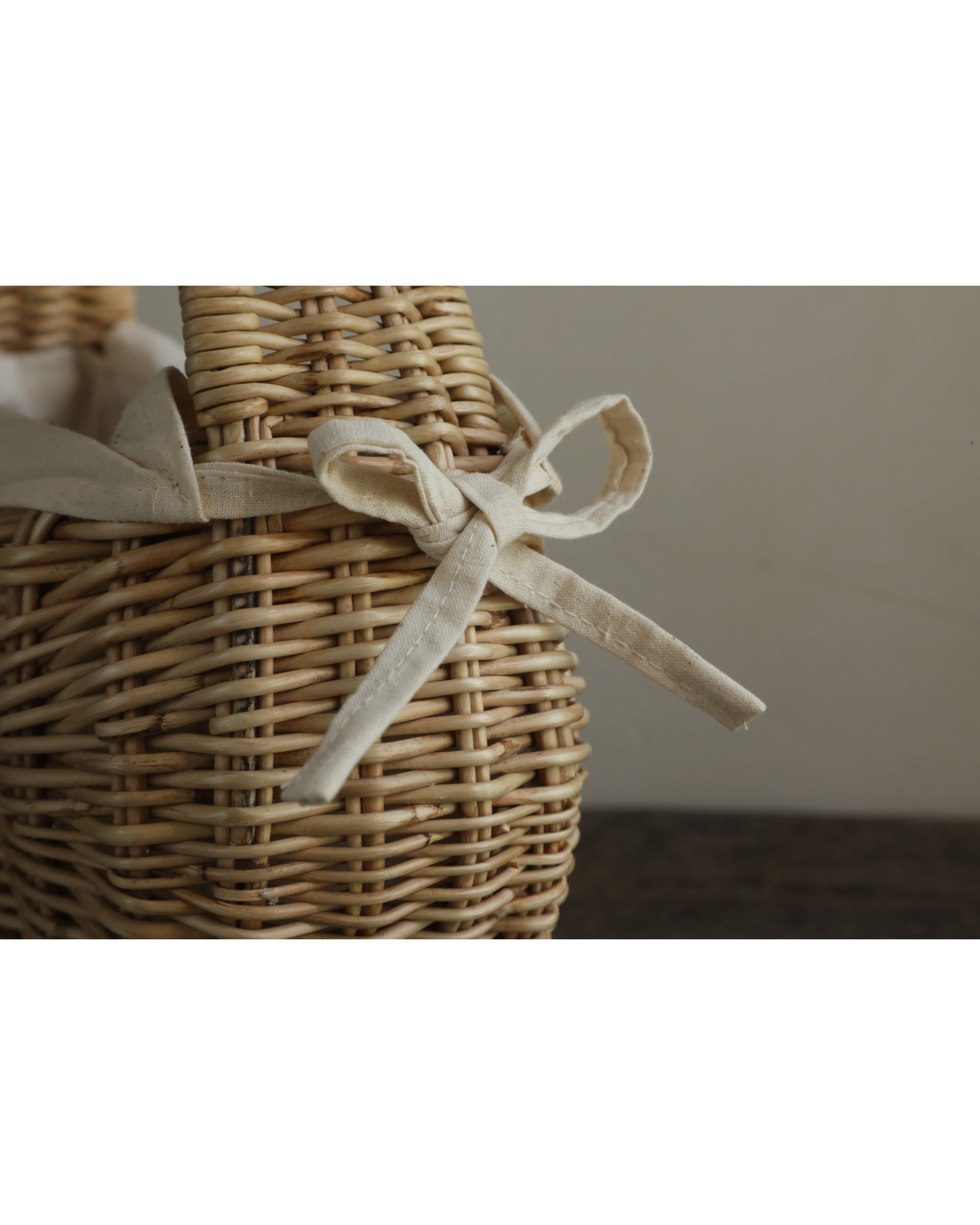 Nora Clutch woven rattan organizer with cream fabric bow detail