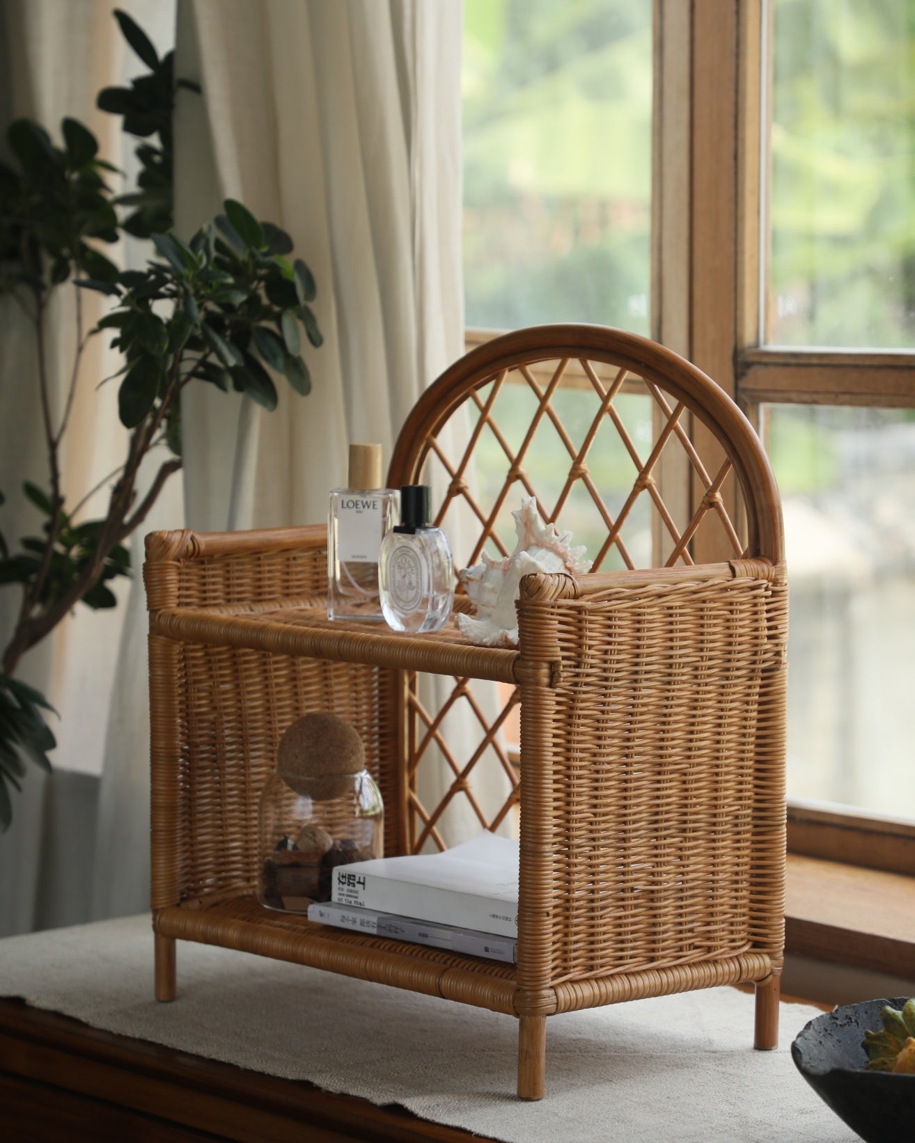 Solana Stand: woven rattan shelf, arched lattice back, open shelves.