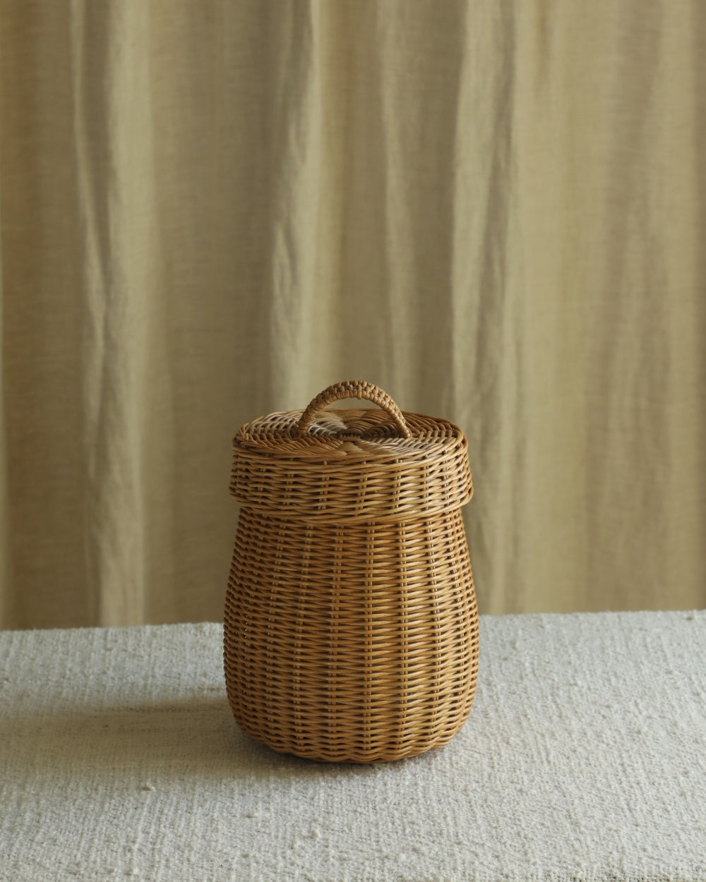 Elodie Round Storage Basket: Woven natural rattan, barrel shape with lid.