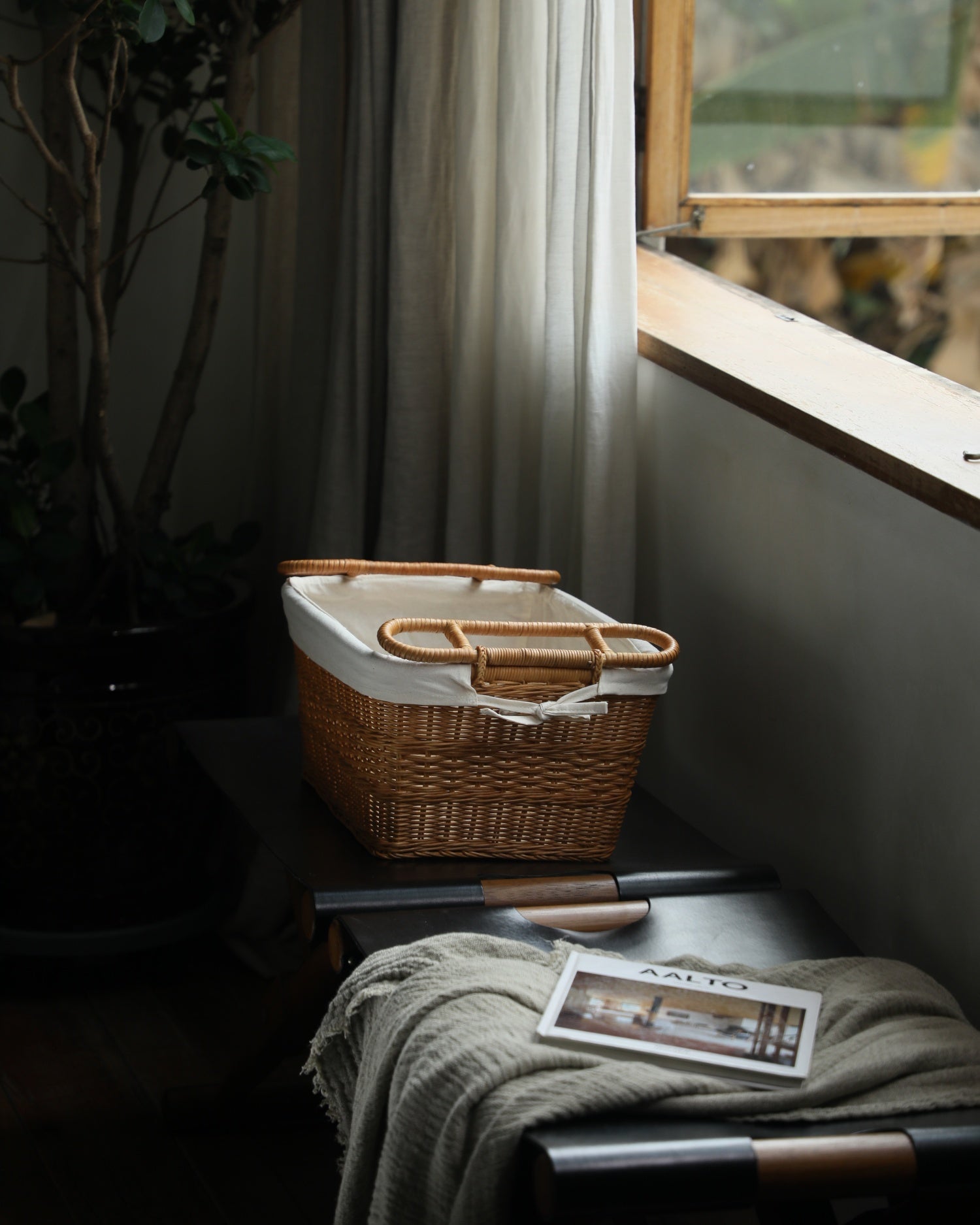 Hilda handwoven rattan storage basket with cotton lining and double handles.