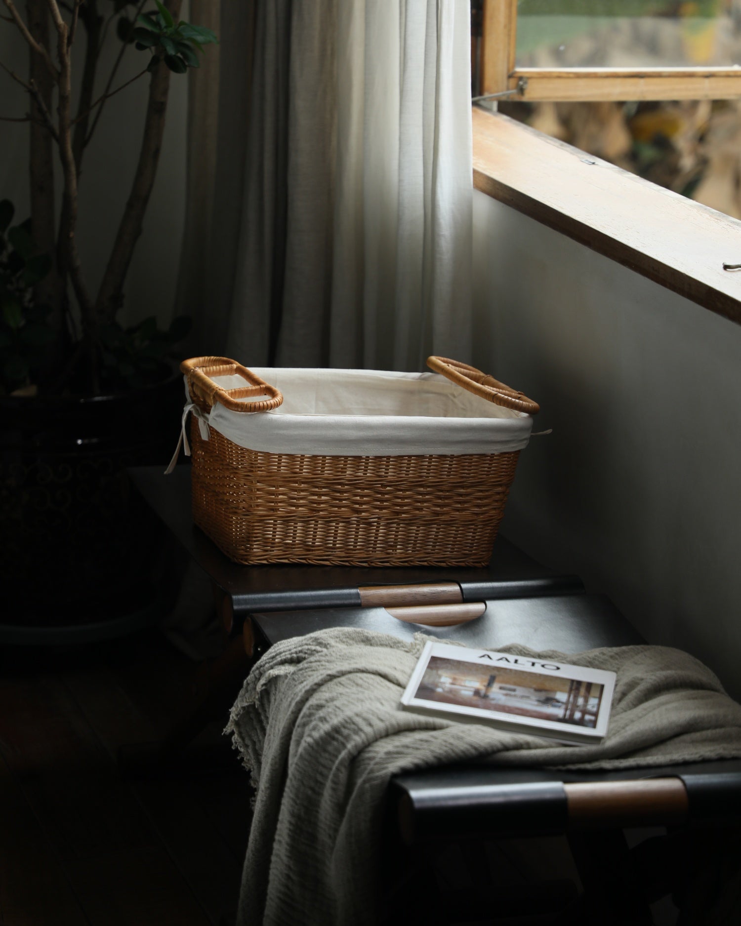 Hilda handwoven rattan storage basket with cotton lining and double handles.