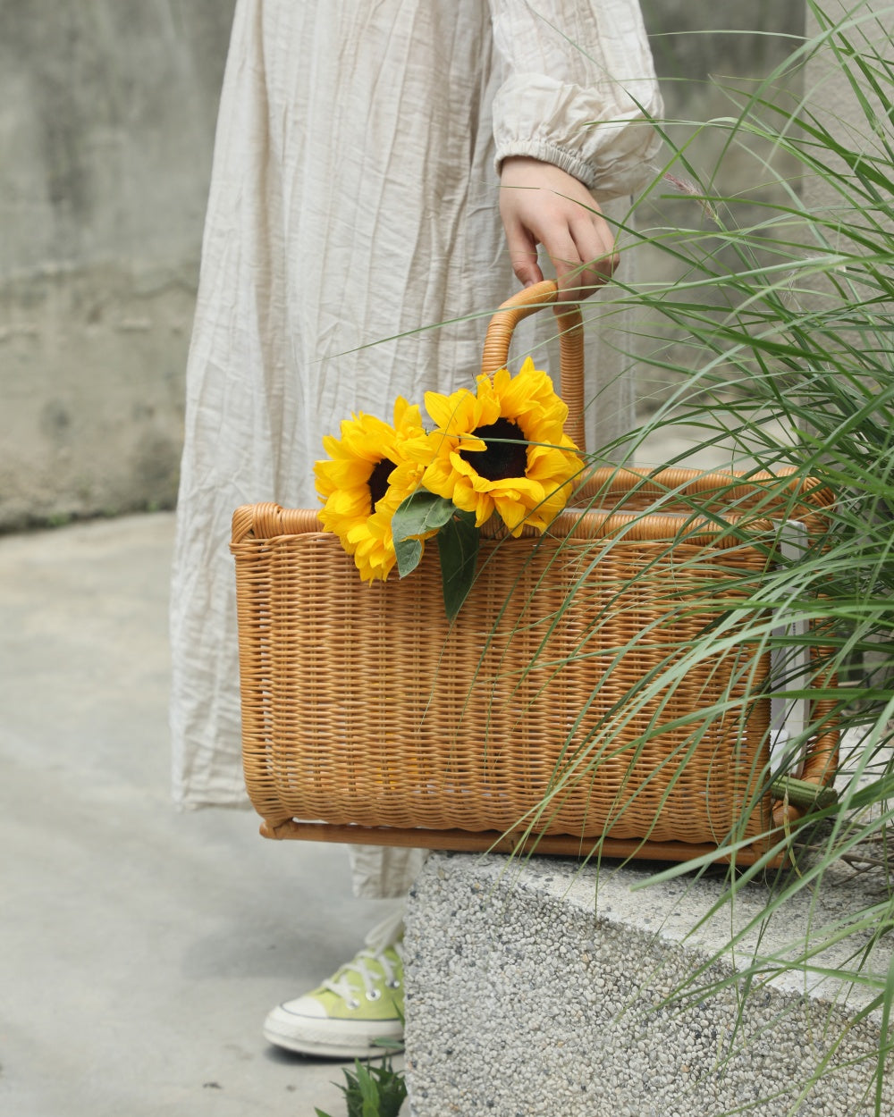 Textured woven rattan Folio Caddy basket with sunflowers, an ideal book organizer.