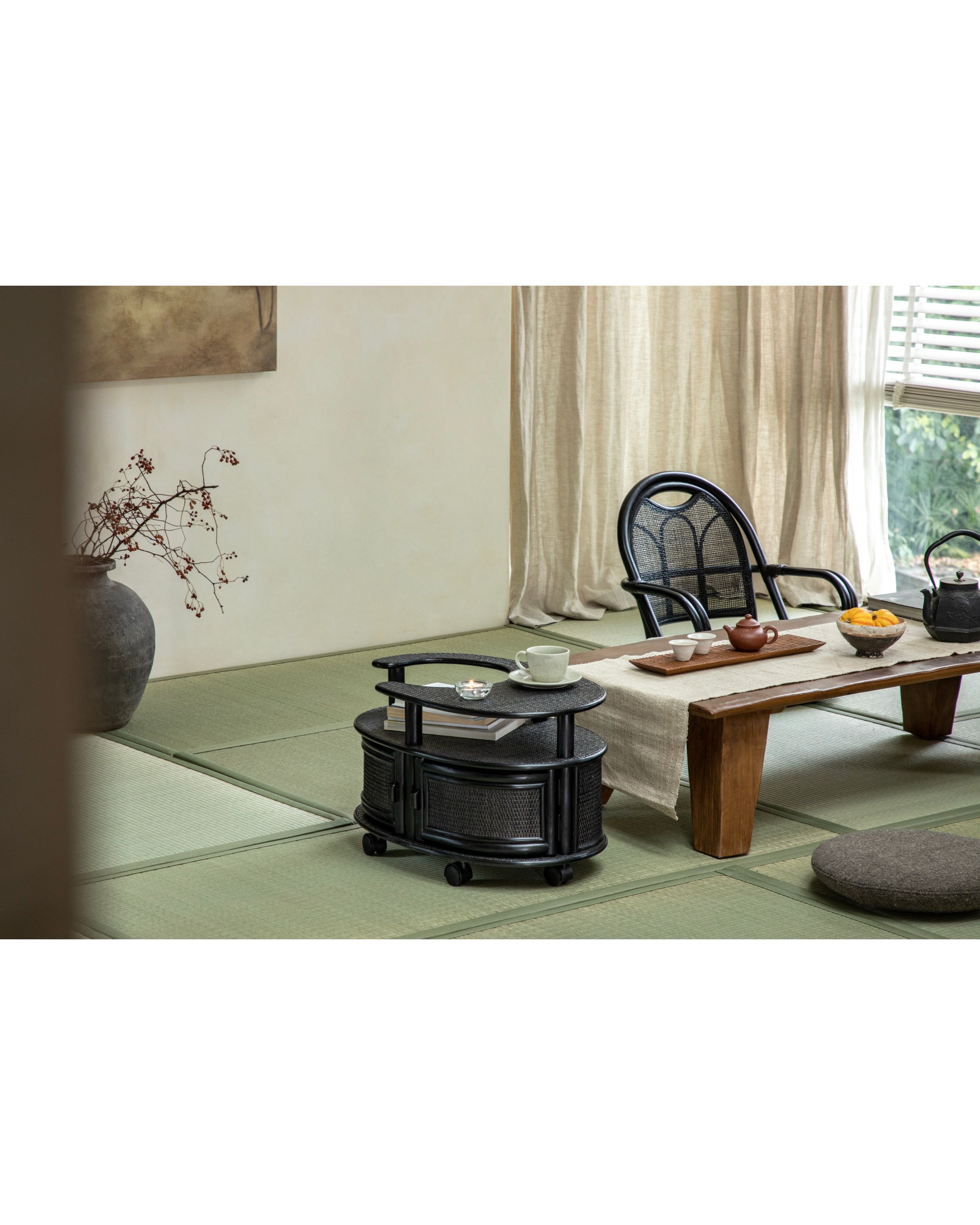 Black Noa Rattan Wheeled Table: double-tier, storage, smooth casters. Manau cane side table.