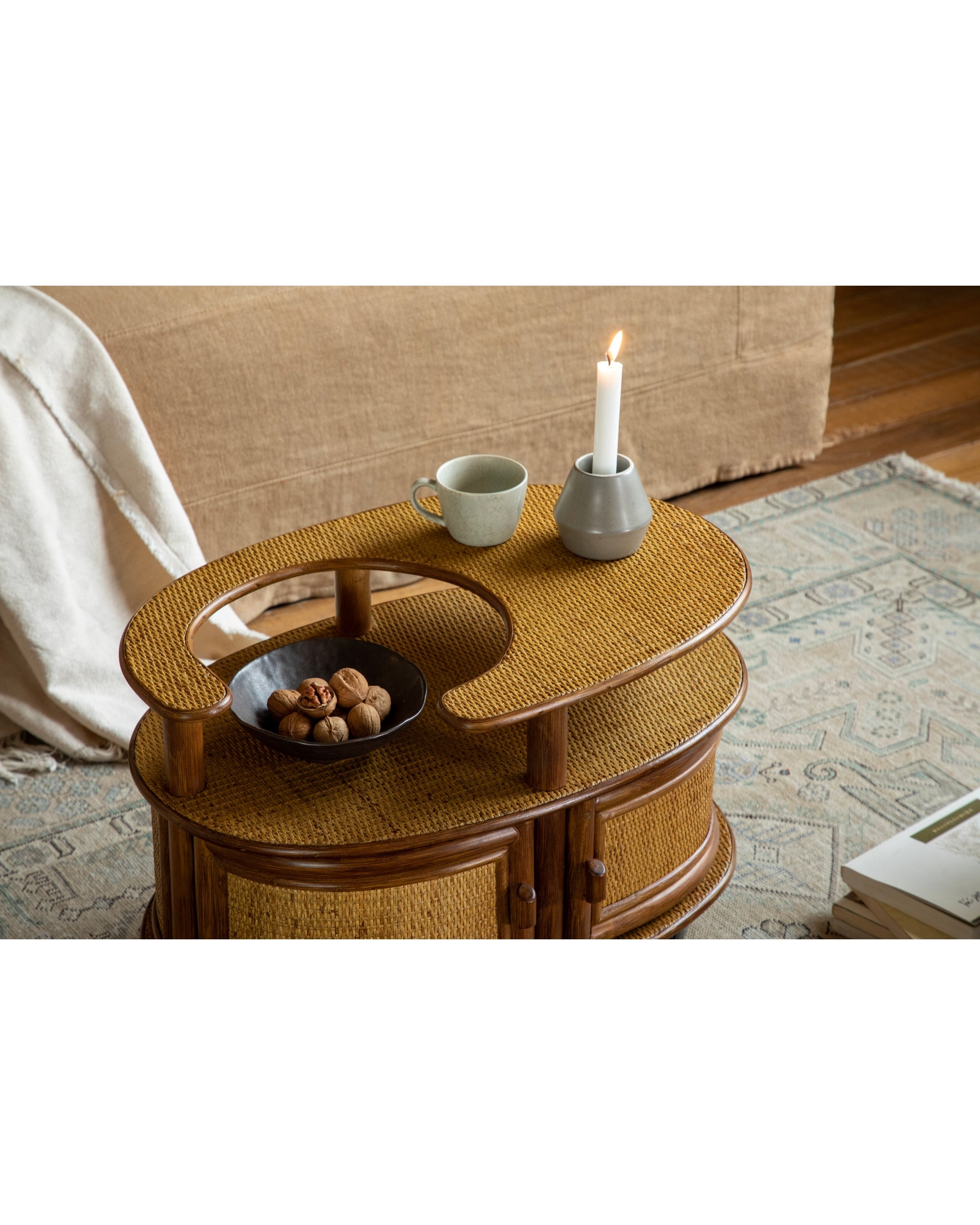 Noa Rattan Wheeled Table: oval, double-layer rattan side table with storage and casters.