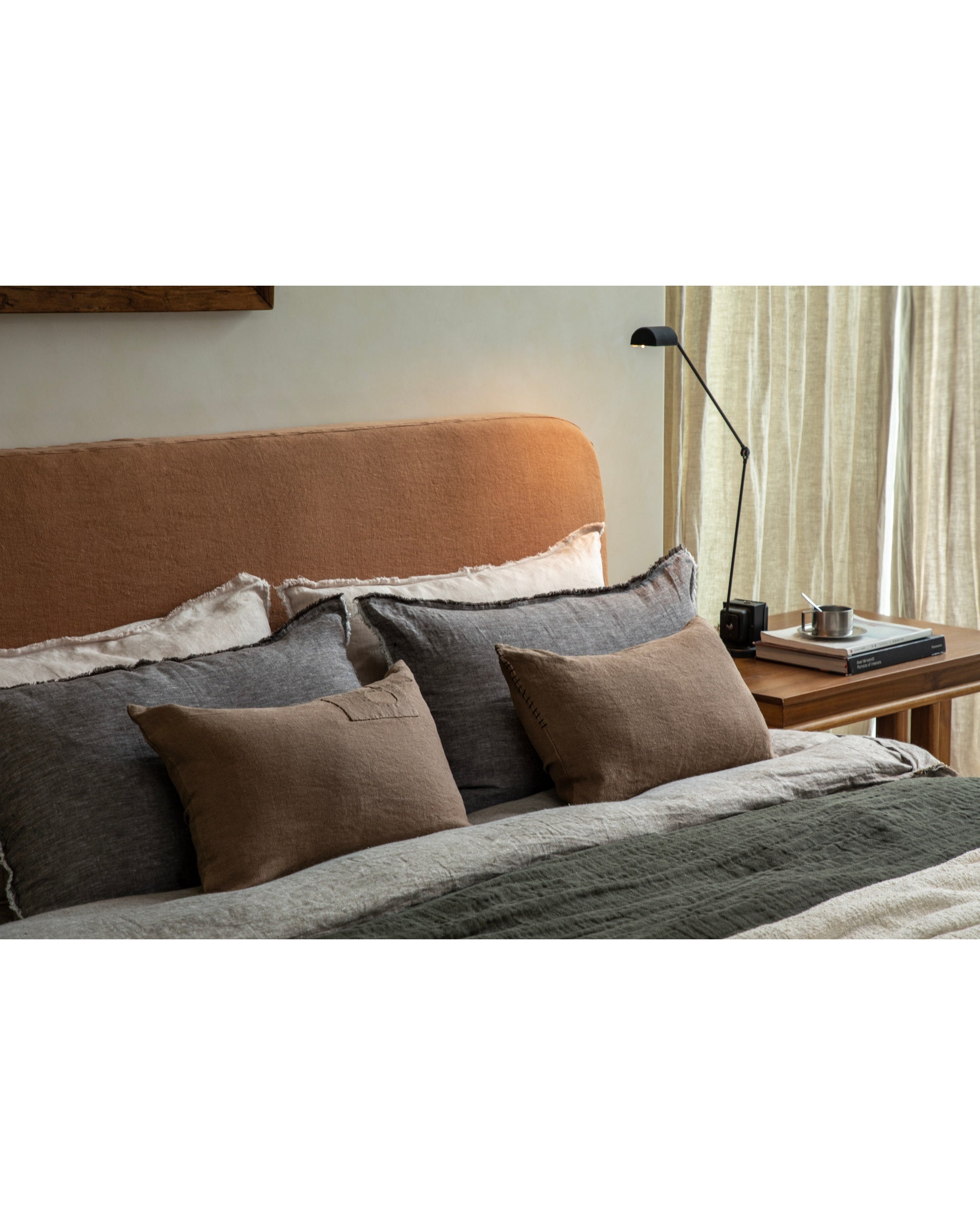 Linora yarn-dyed linen pillows feature handcrafted details in earthy, grey, and green tones.