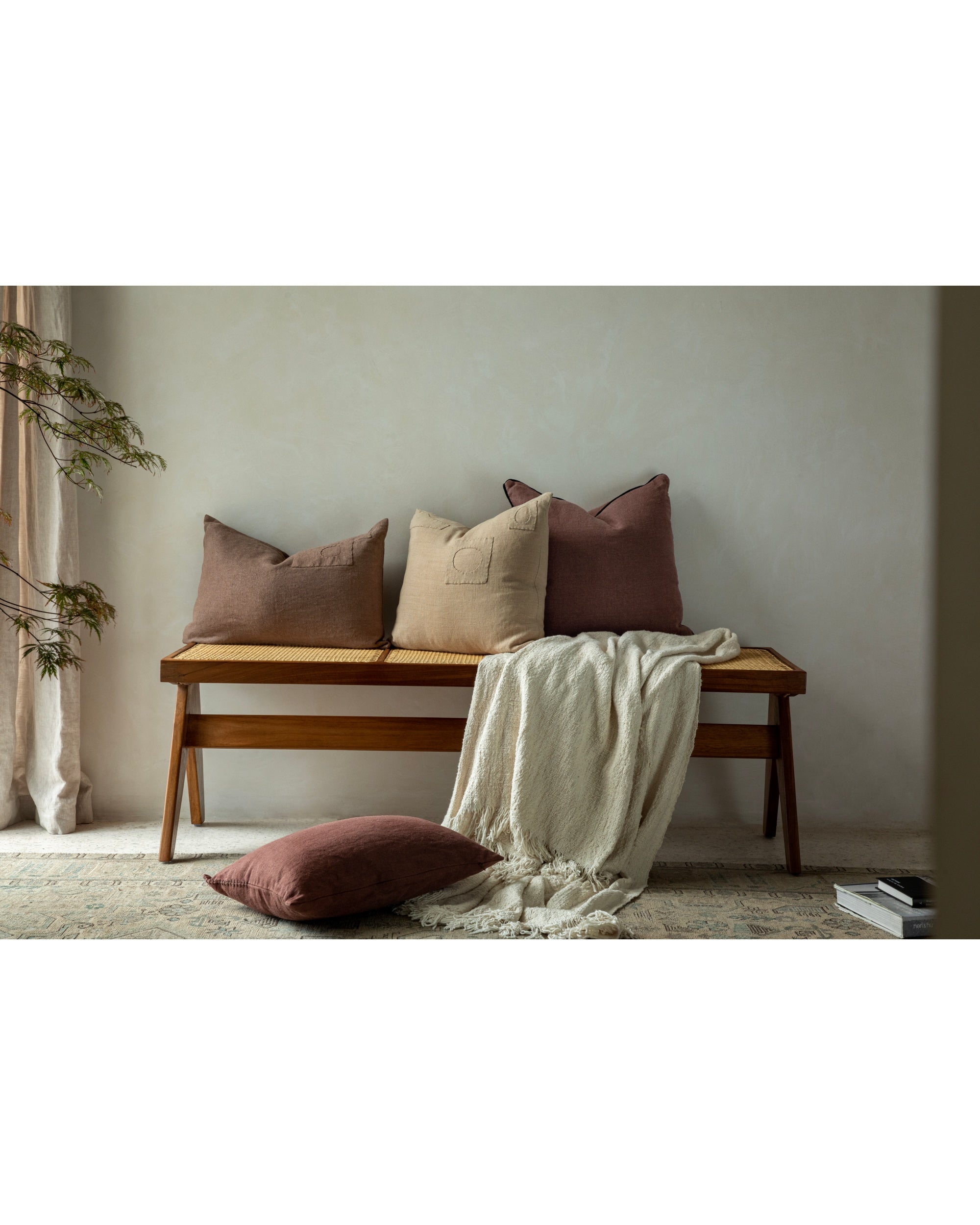 Yarn-dyed linen Linora pillows in muted pink & natural tones with patchwork details.
