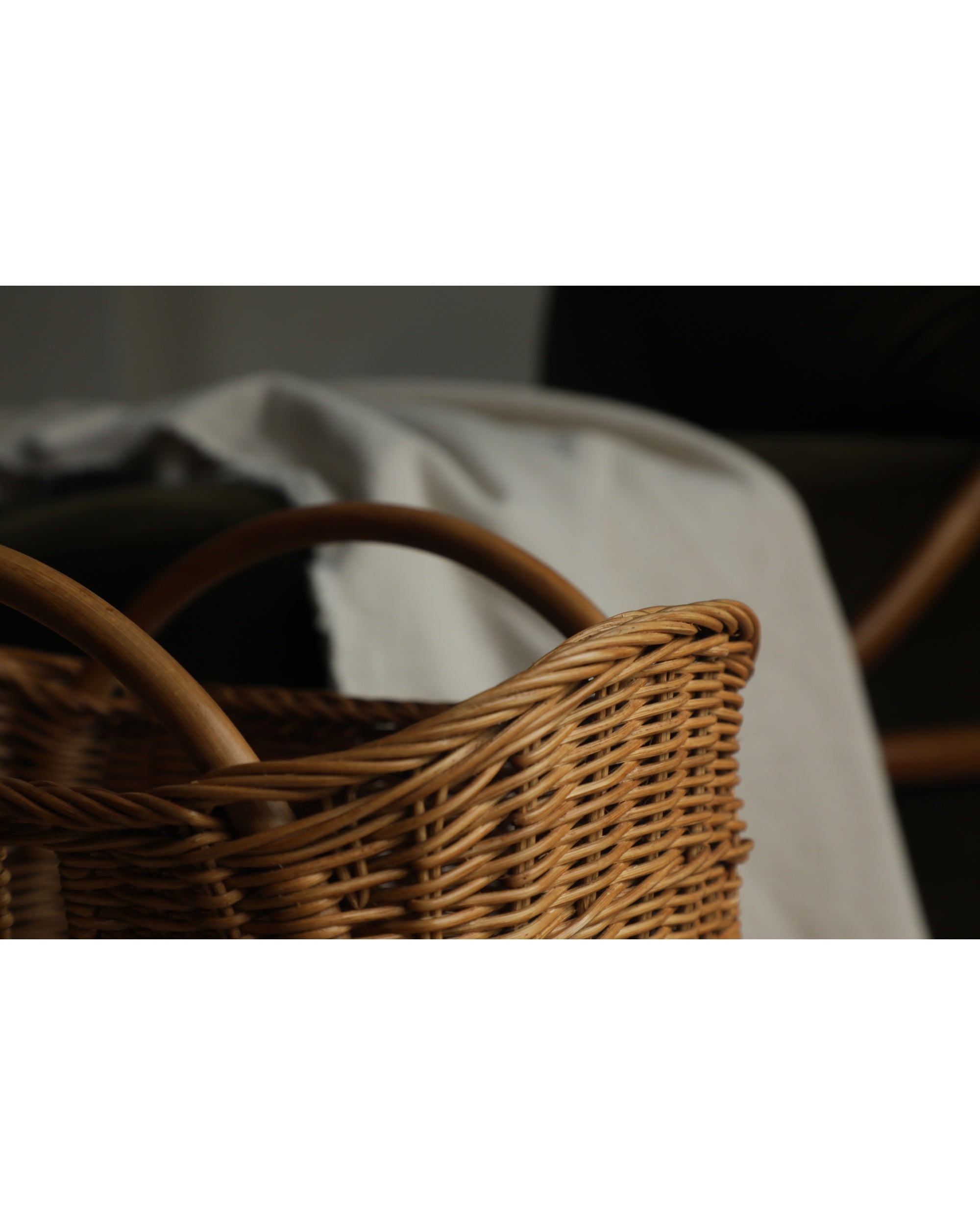 Luna Storage Basket: Handwoven natural rattan with tapered design and wooden handles.