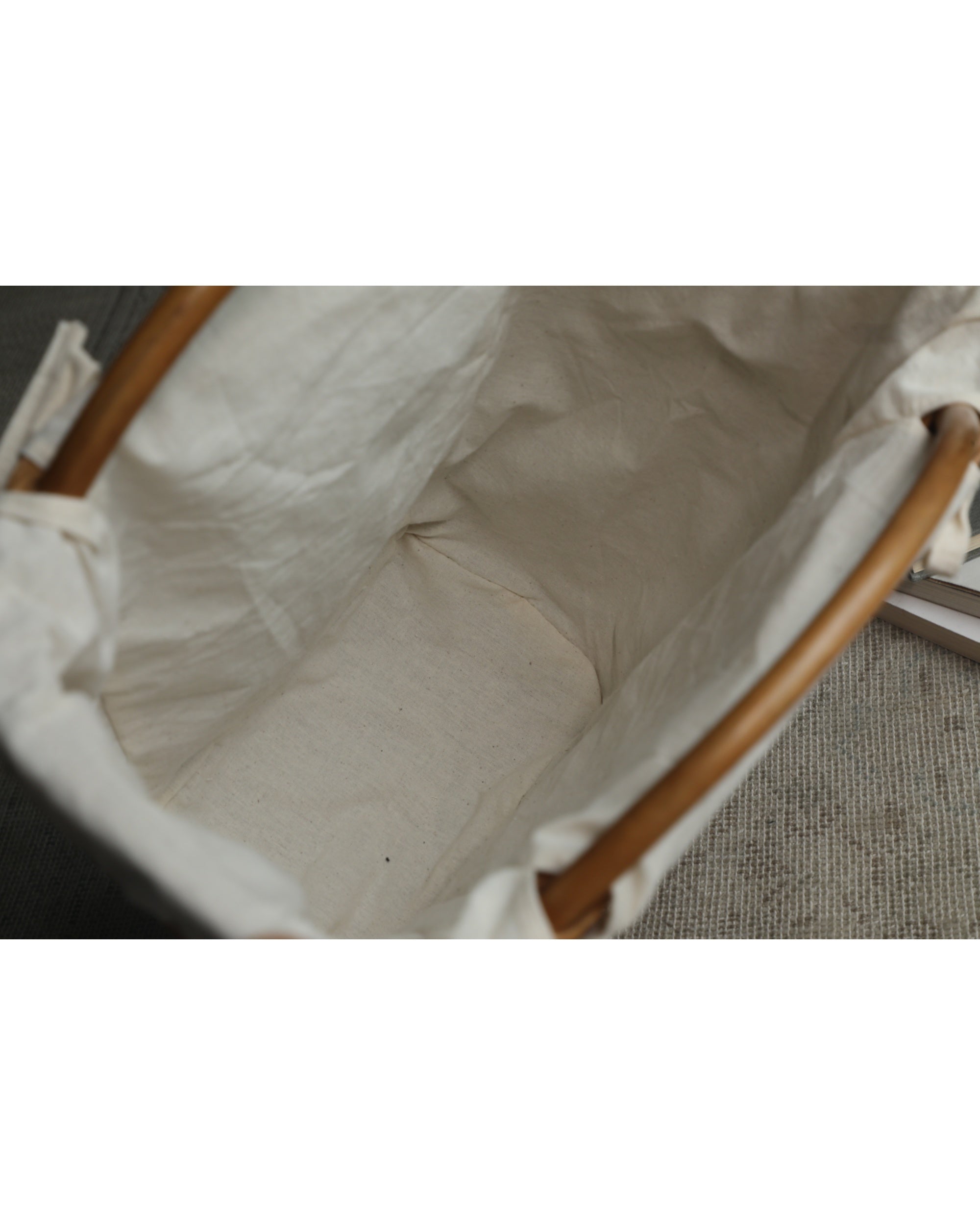 Luna Storage Basket interior with cream cotton lining and natural rattan handles.
