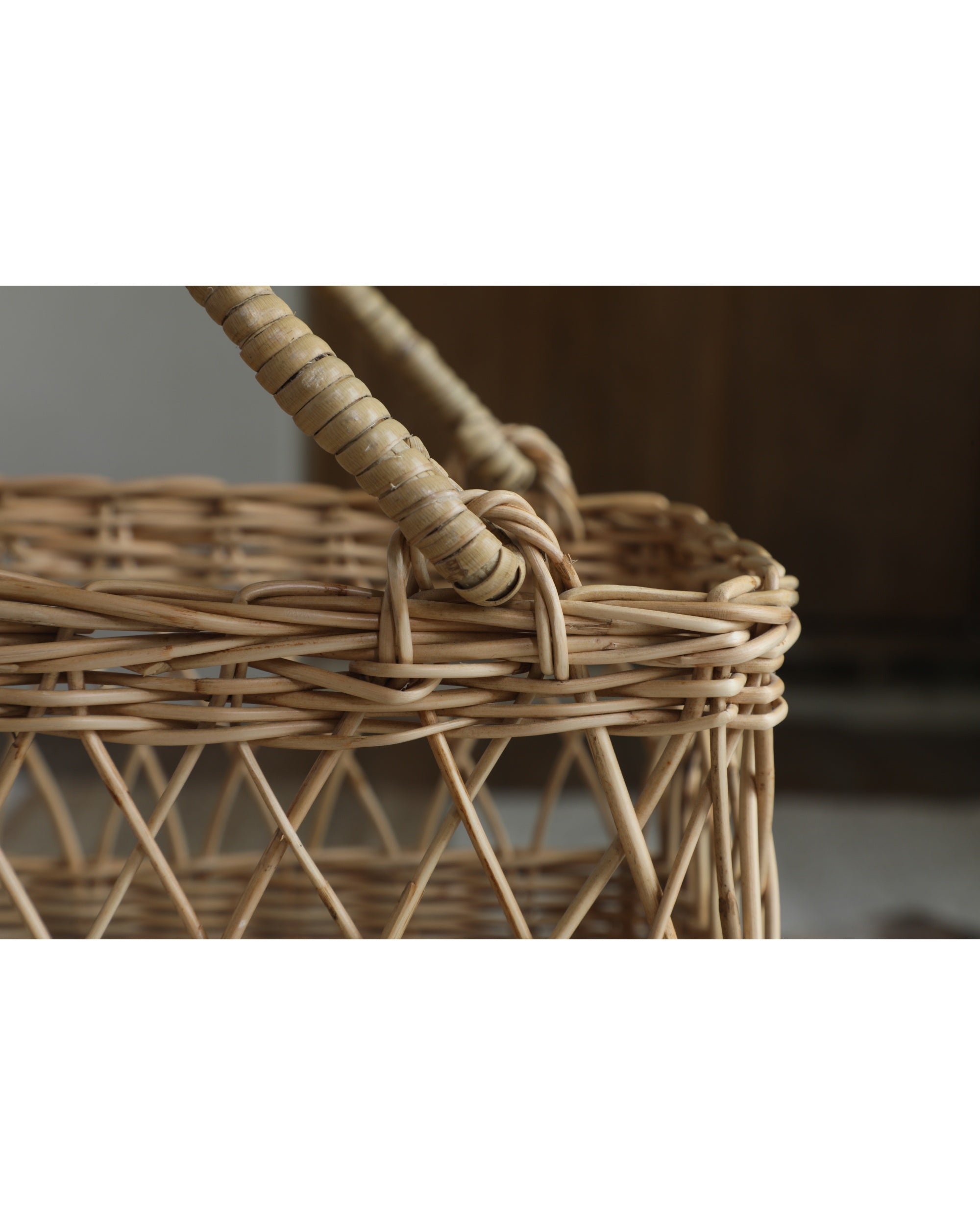 Natural woven rattan Lina basket with dual-texture weave and curved handles.