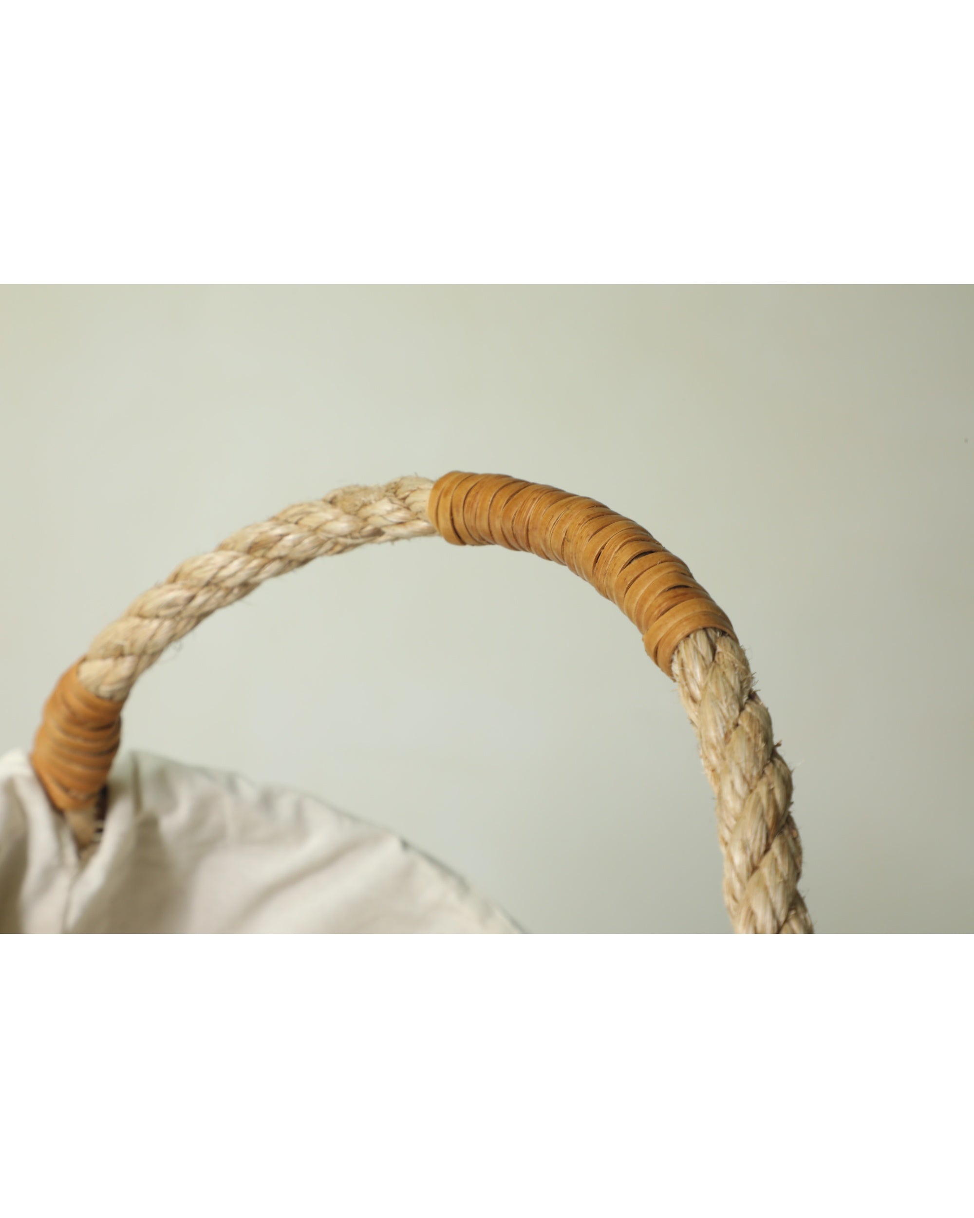 Braided handle on Aurelia Basket with woven rope and tan wrapped grip
