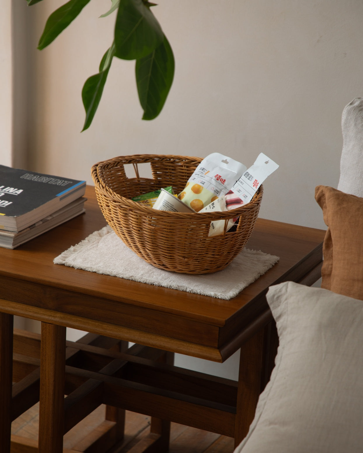 Dottie natural rattan basket, handcrafted with rustic texture, holding snacks.