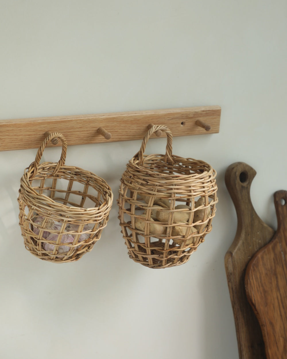 Cove hanging basket: Hand-woven rattan with arched handle, kitchen storage.