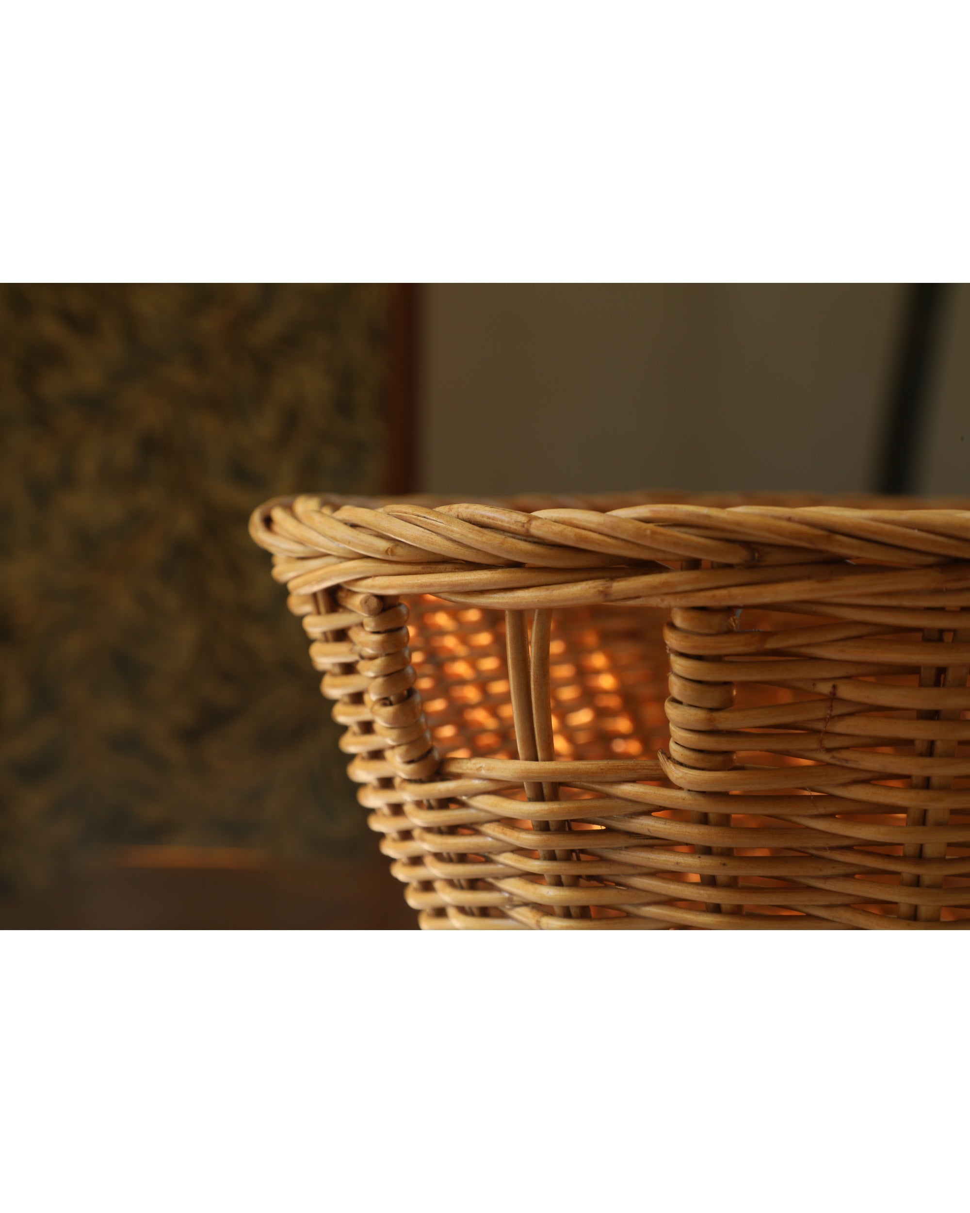 Close-up of the woven natural rattan Dottie Basket, showing its intricate texture.