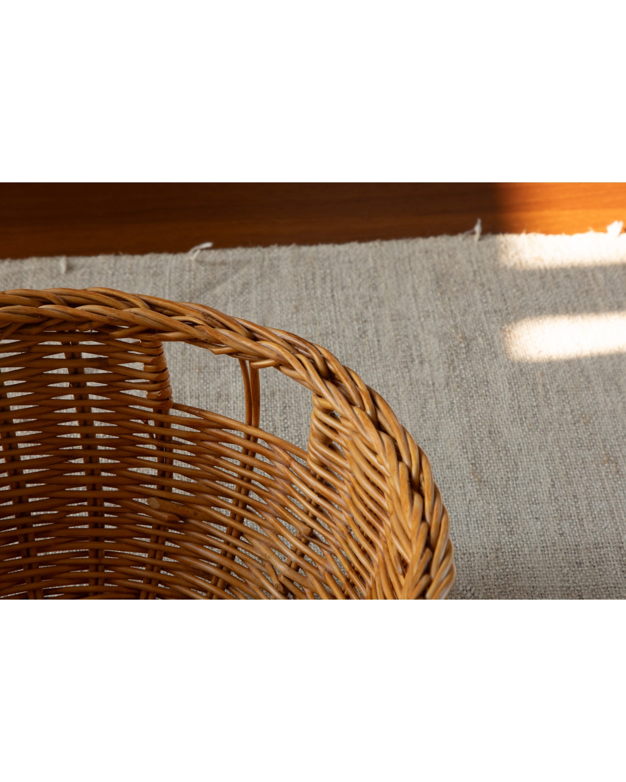Dottie Basket, hand-crafted from natural woven rattan, close-up texture detail.