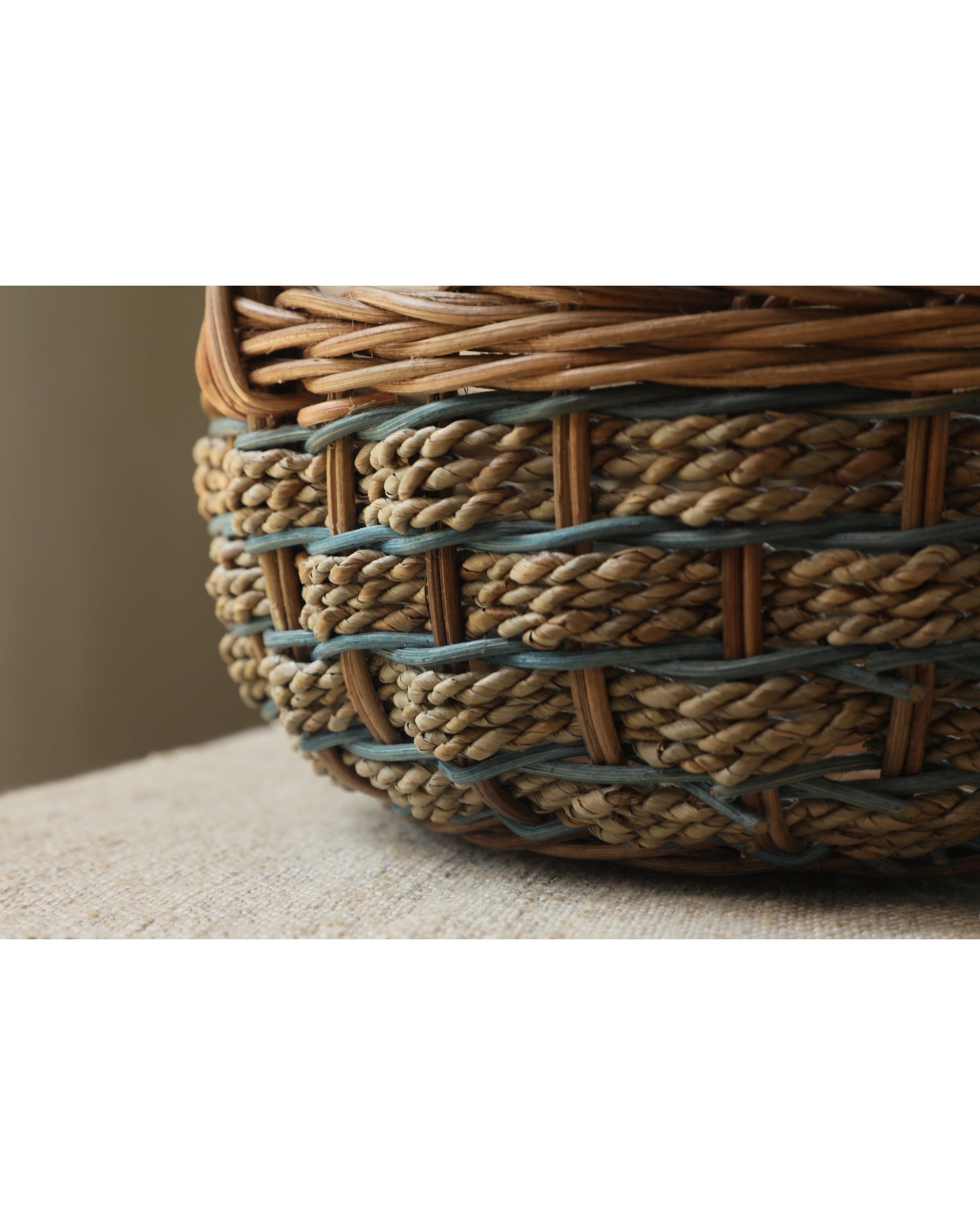 Viney Tote Basket, natural rattan woven with green vine accents.