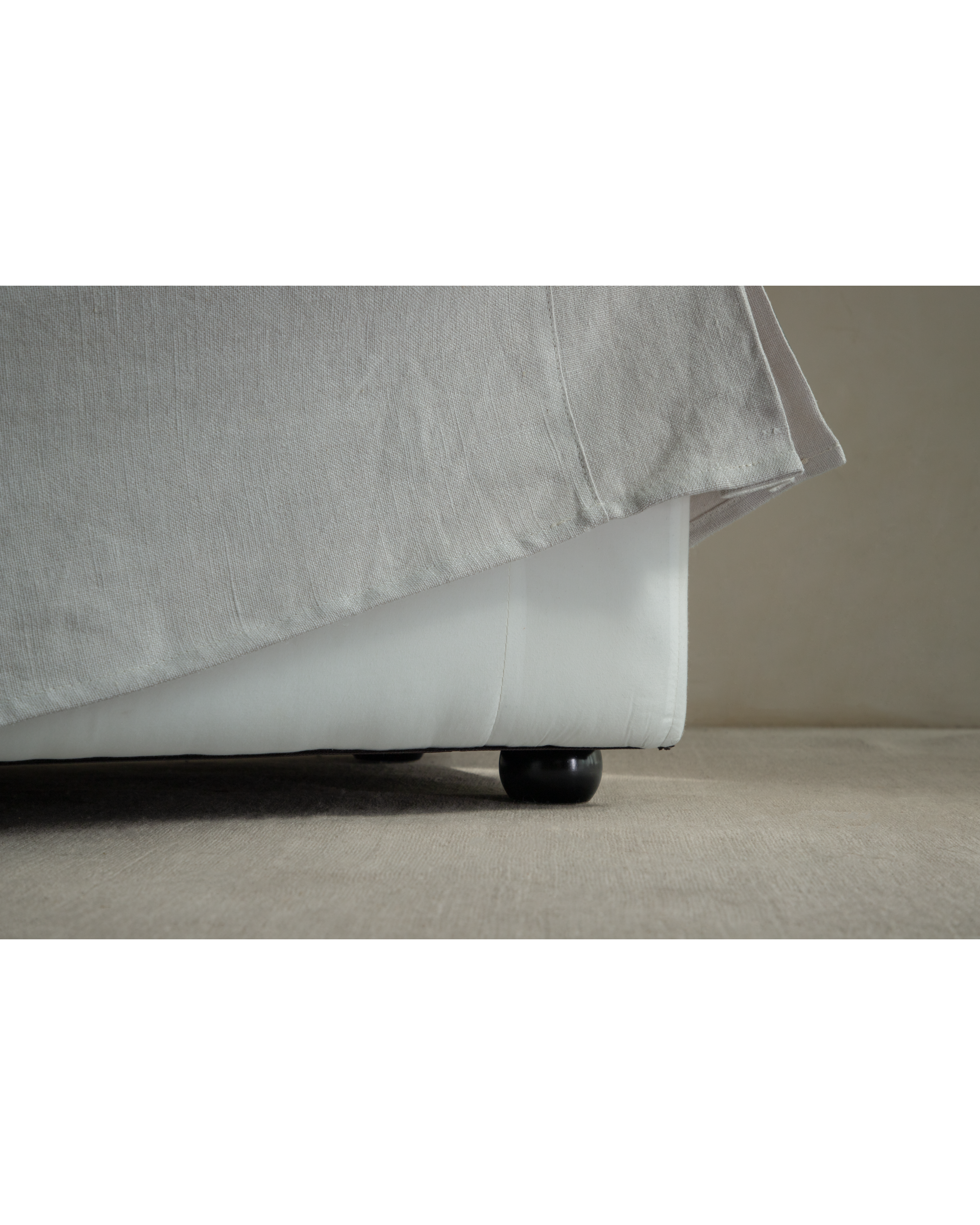 Alina Bench in Linen Gray, showing textured yarn-dyed linen fabric and black round legs.