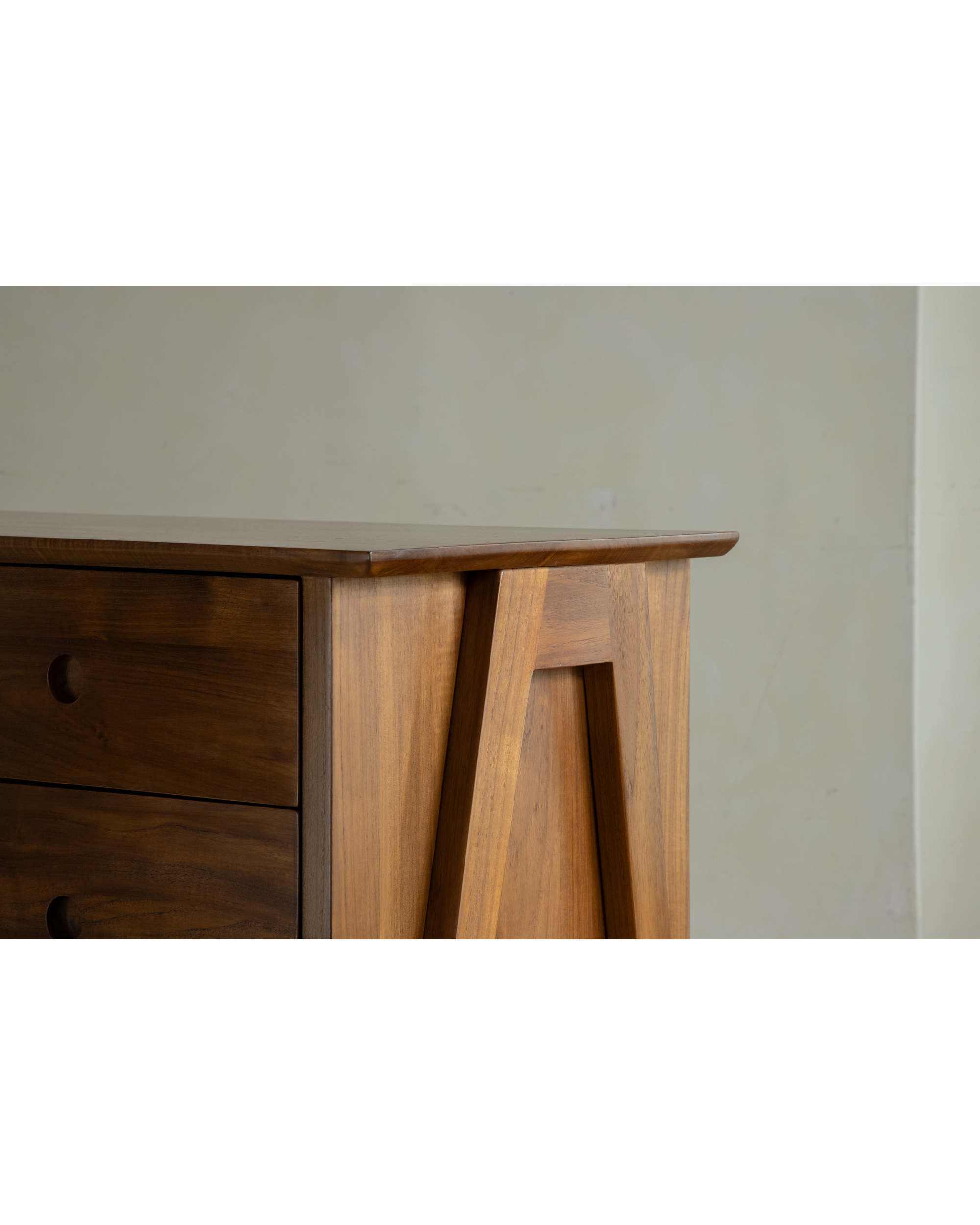 No.23 Teak sideboard with warm wood grain, round drawer handles, and geometric angled side panel.