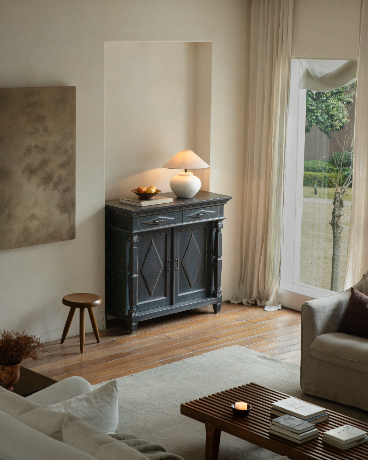 Victoria Teak Cabinet in a modern living room, black vintage-style storage cabinet with brass handles