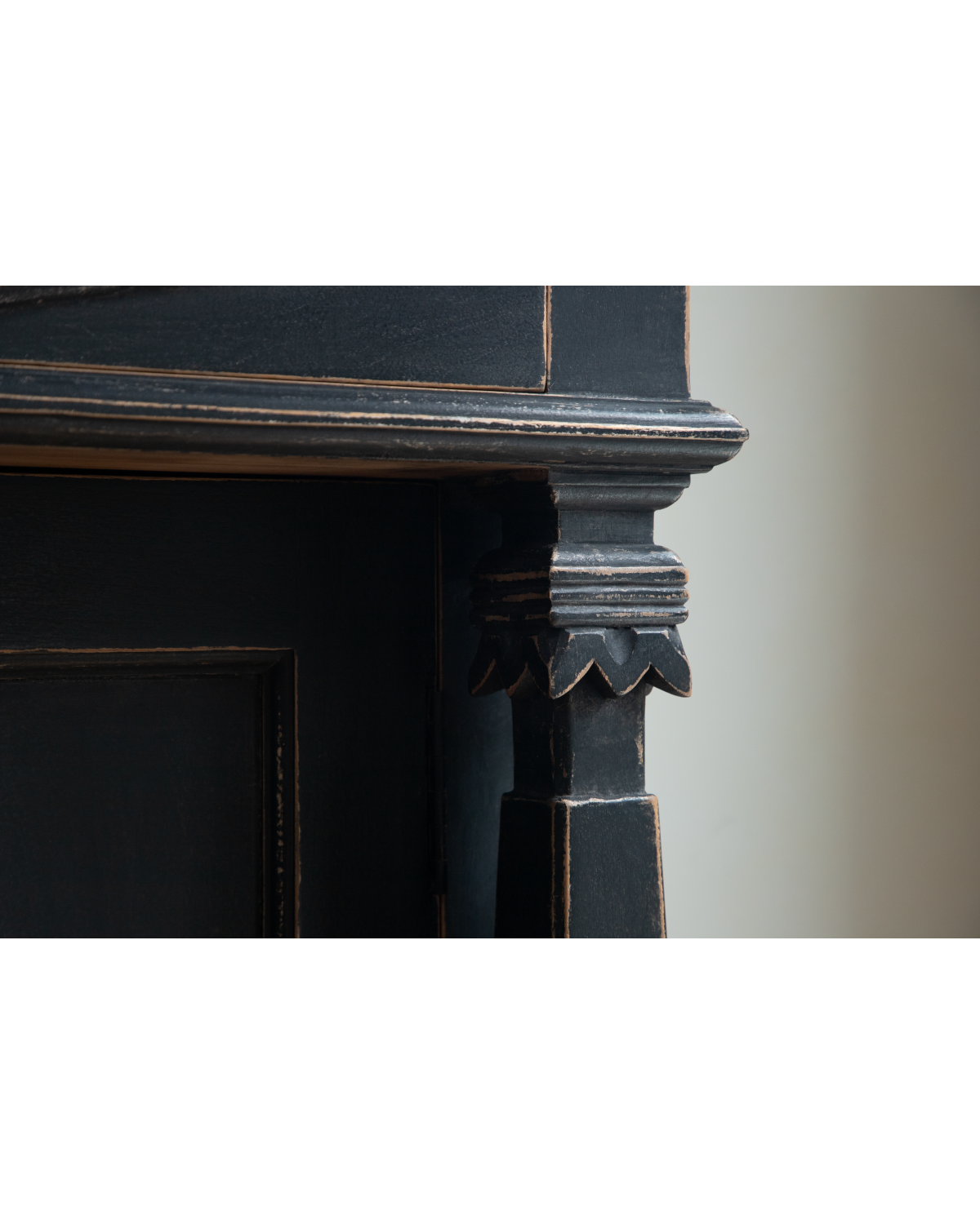 Close-up of Victoria Teak Cabinet carved Roman column and antique black finish