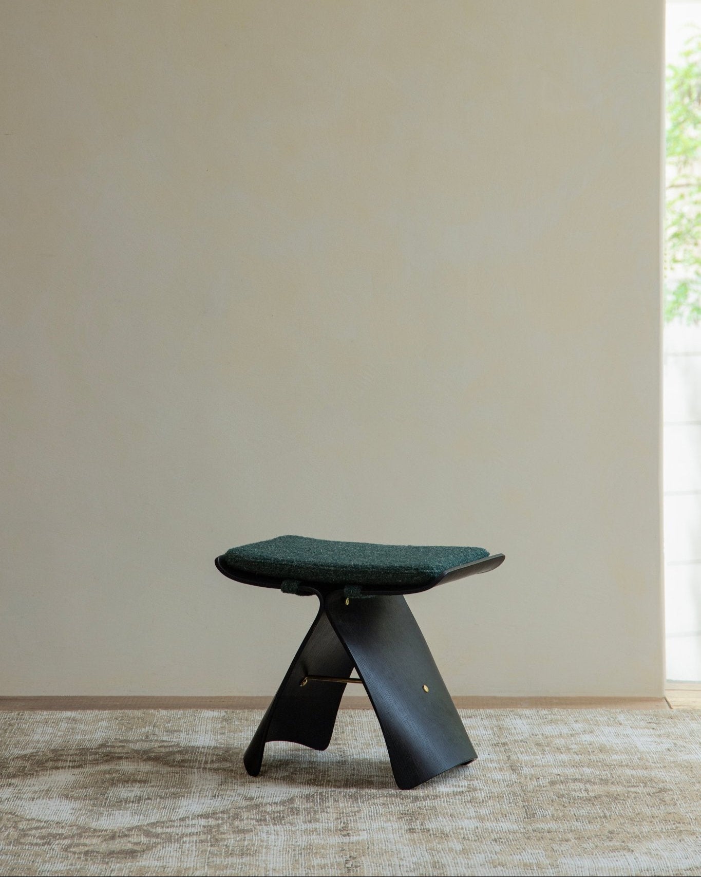 Carbonized Black Butterfly Stool with green cushion, modern design for elegant seating