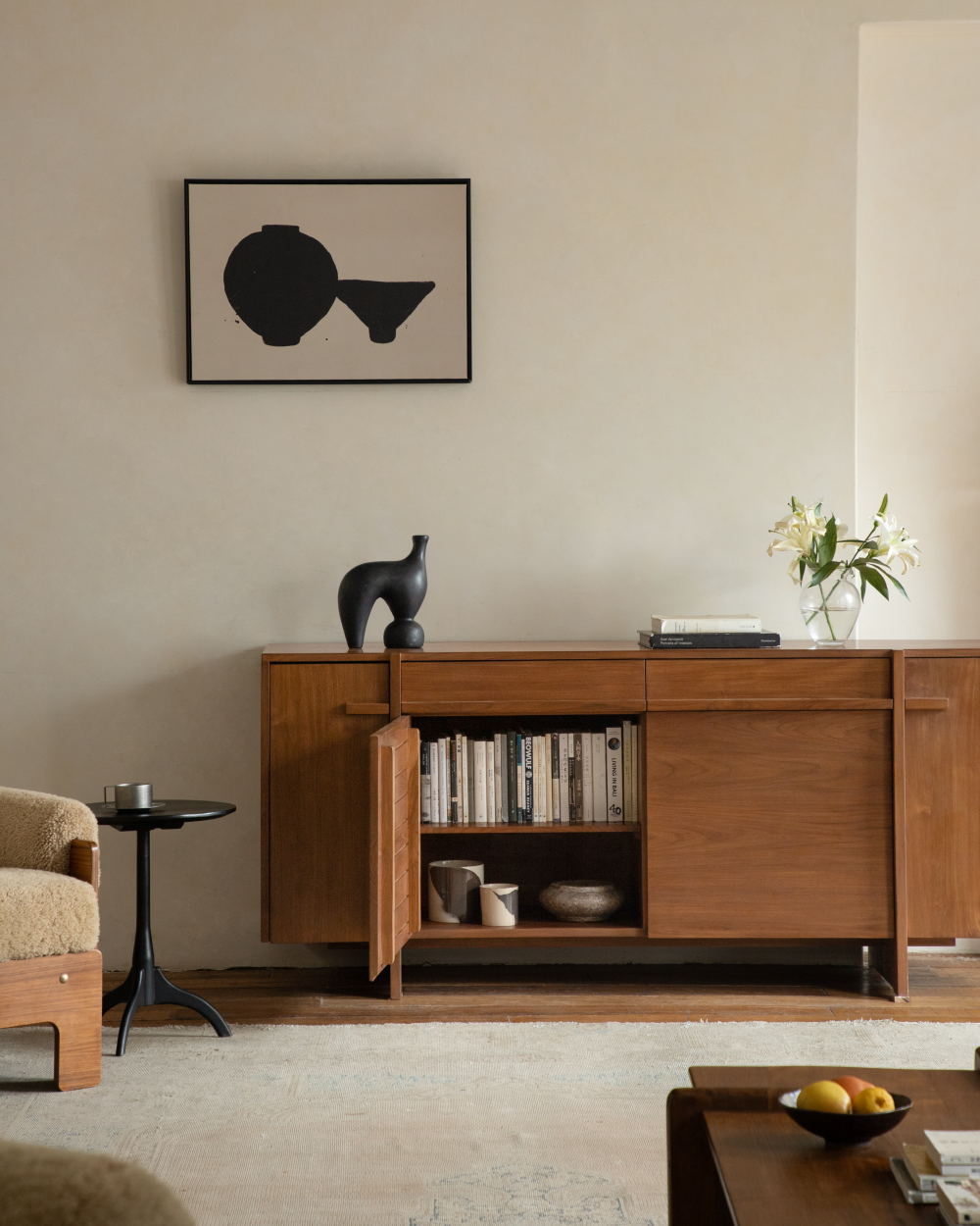 NO.42 Teak Sideboard with open door, revealing book-lined shelves and decor.