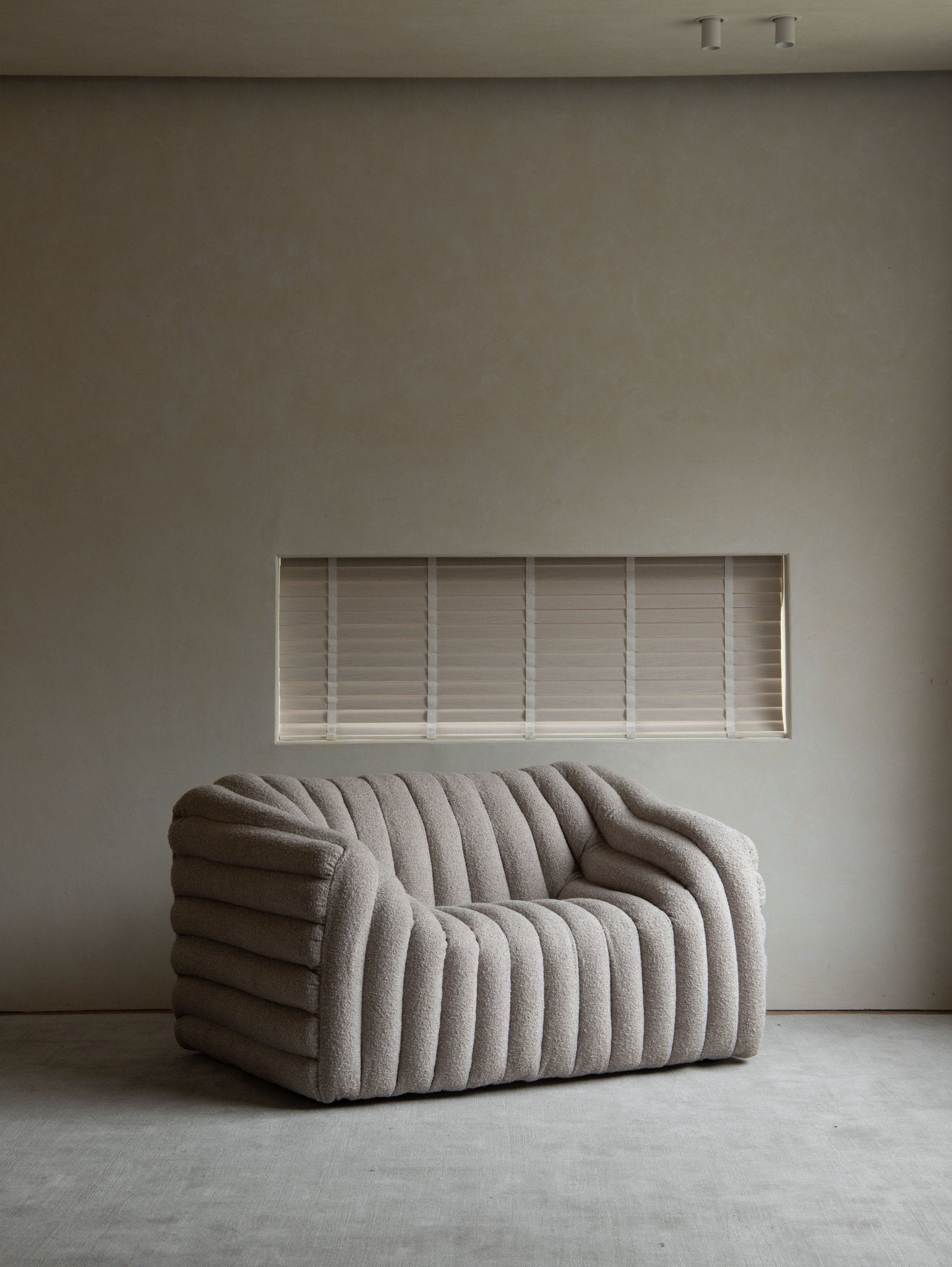 Miche Sofa in beige with vertical ribbed design in a modern living room