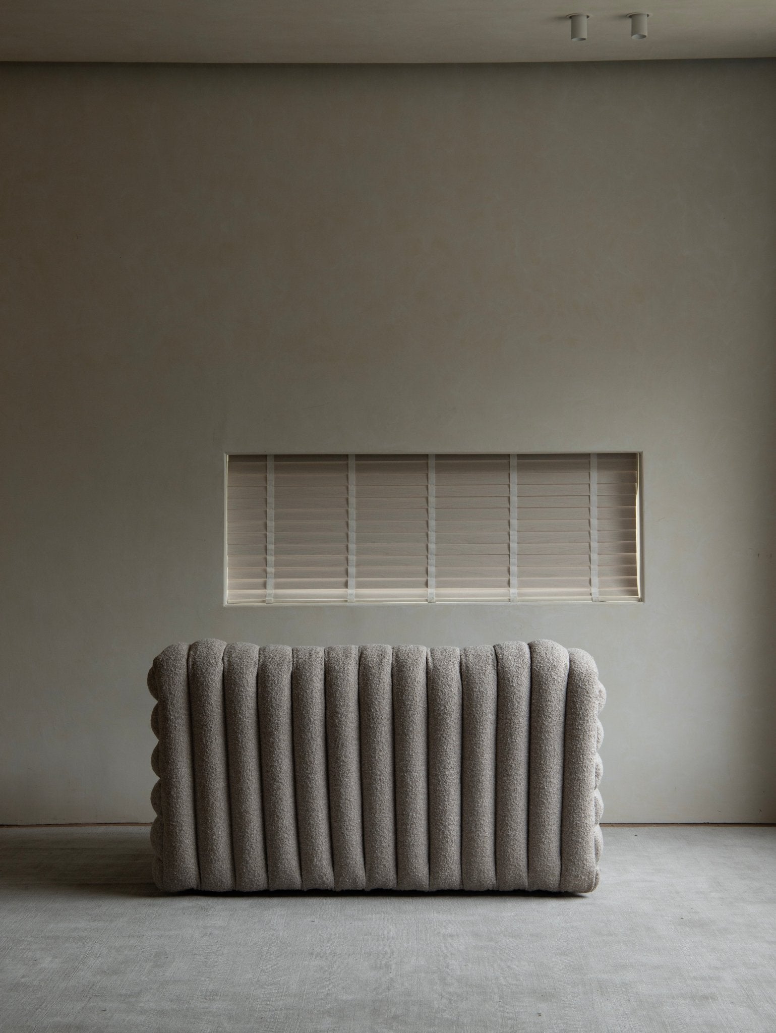 Miche Sofa in beige, vertical ribbed design, soft fabric, cozy living room setting, modern style.
