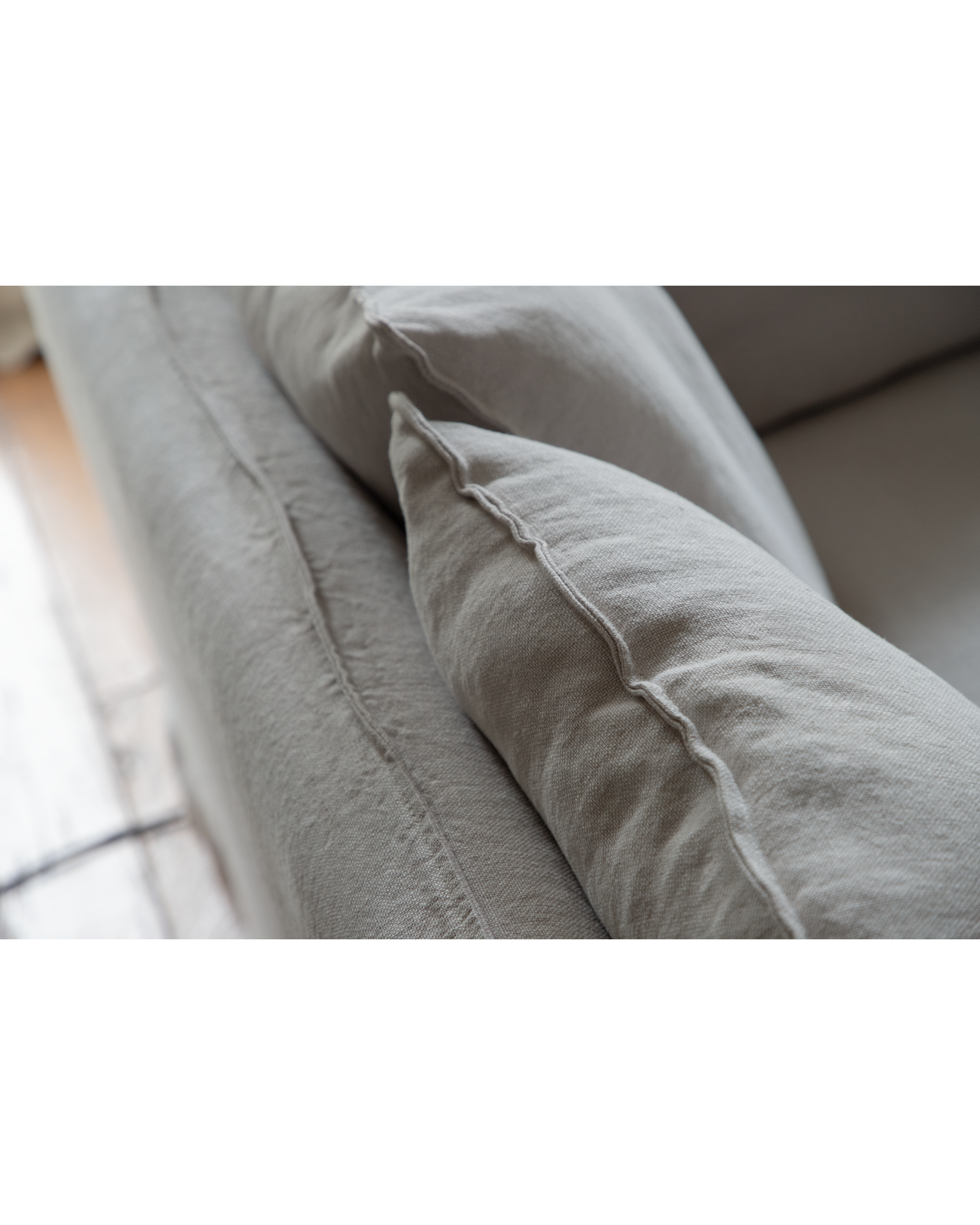 Close-up of textured linen fabric and stitching on the Camille Sectional Sofa.