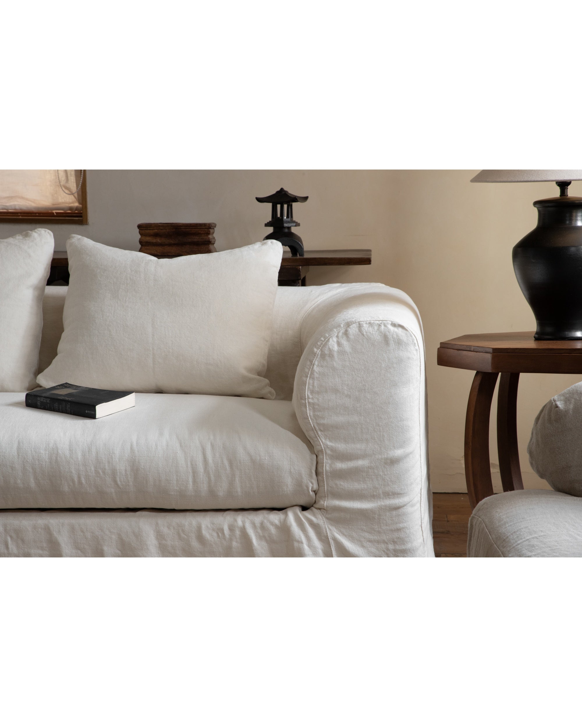 Charlotte Sofa in White Tea textured linen with black book on seat.