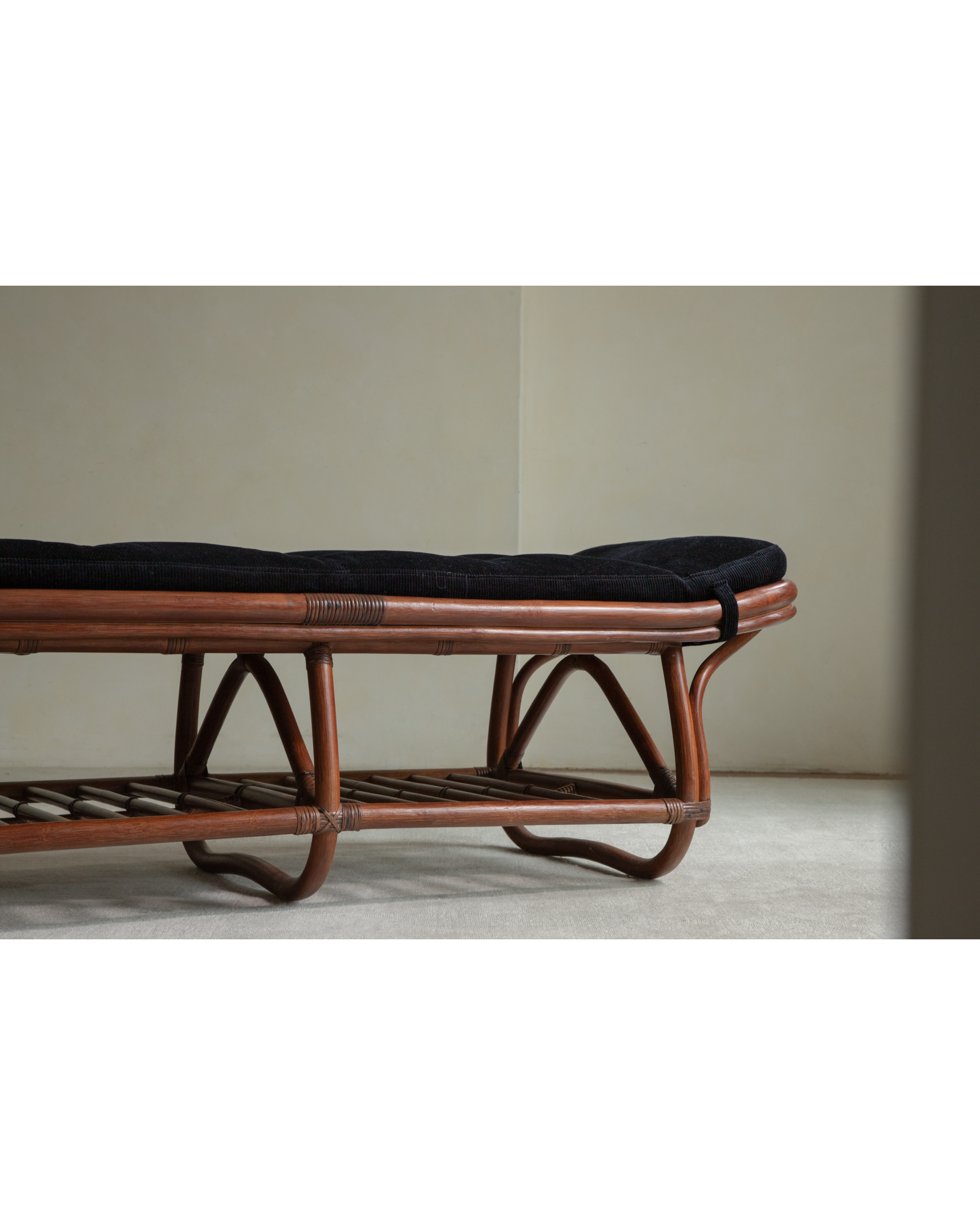 Twyla rattan storage bench with curved legs, black corduroy cushion, lower shelf