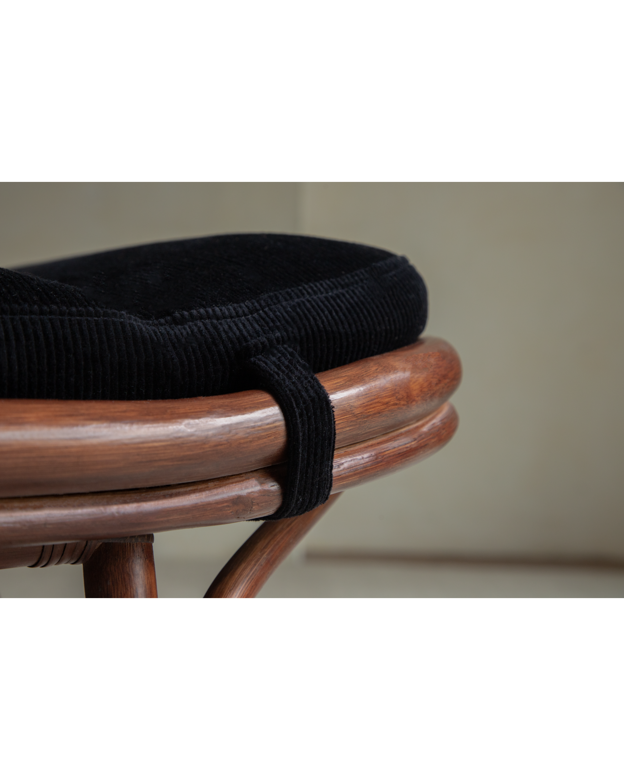 Twyla Storage Bench: Black corduroy cushion texture on rattan frame.