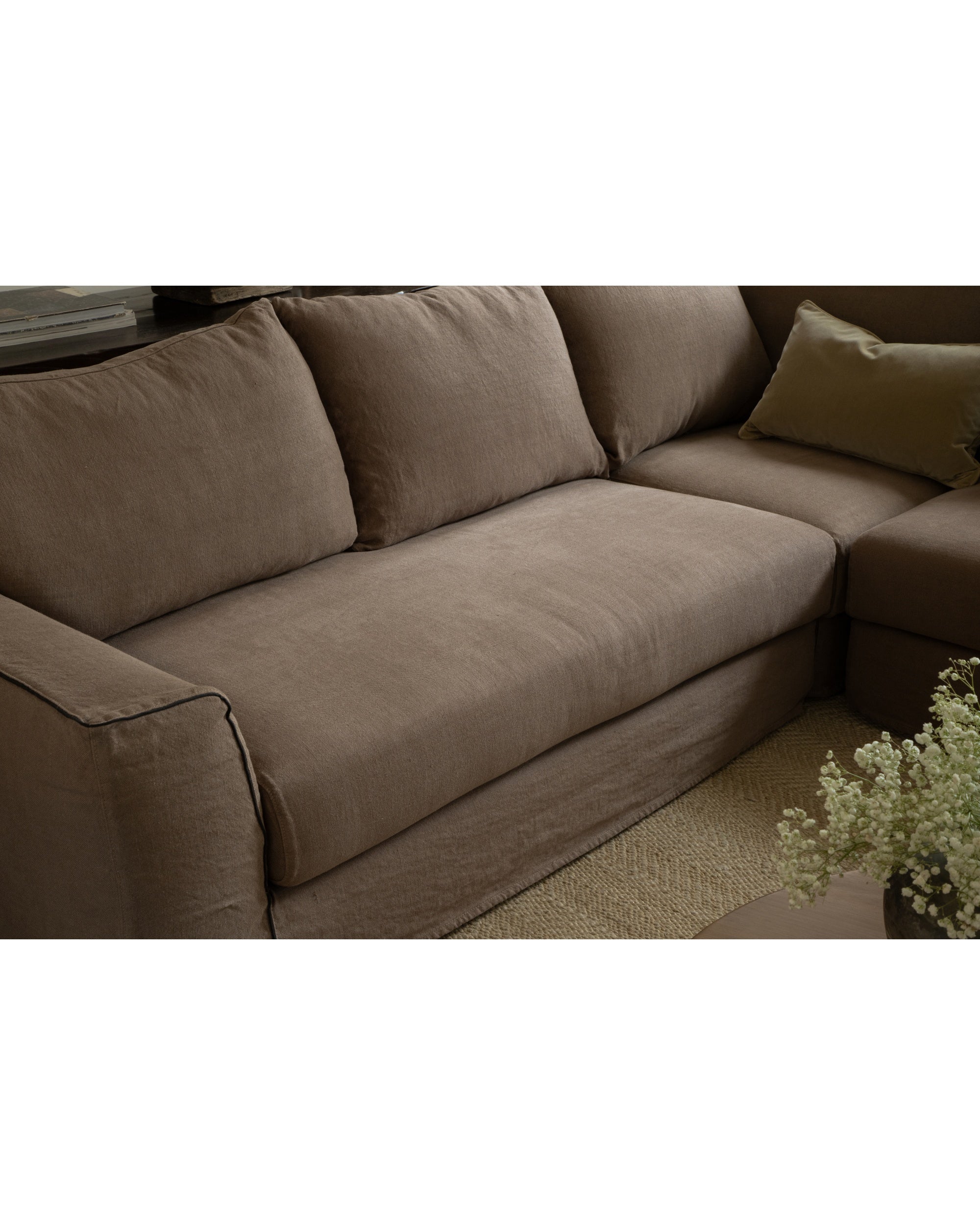 Noa modular sectional sofa in taupe Belgian linen, featuring plush cushions and piping detail.