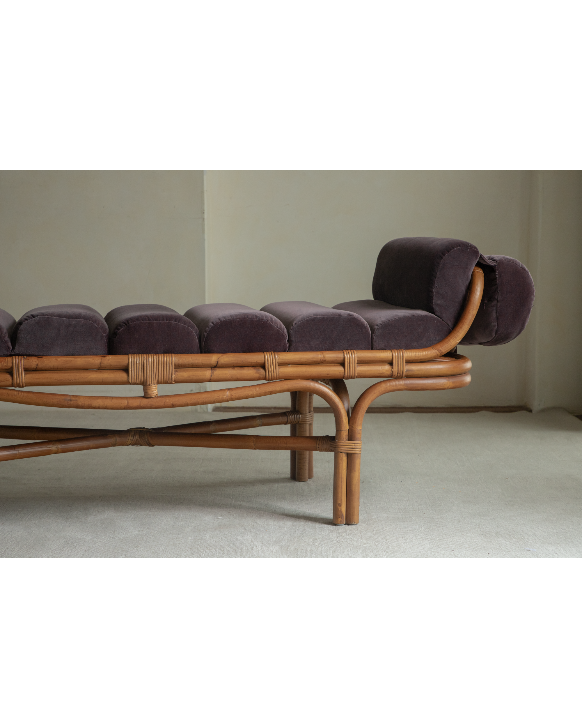 Bridget Bench with natural rattan frame and plush aubergine velvet cushions, elegant tropical design.