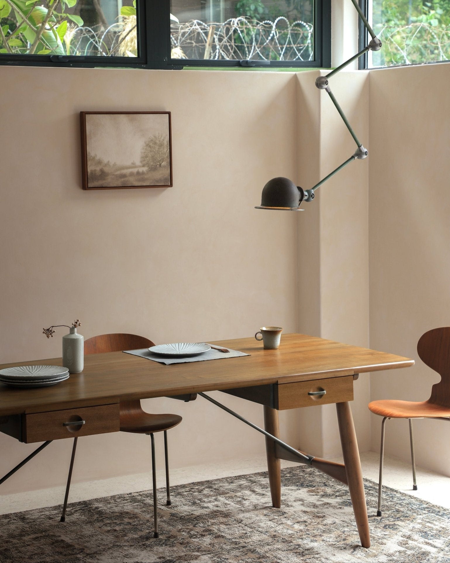 Architect Desk in a dining setting. Teak wood table with brass accents, dining chairs and modern lamp.